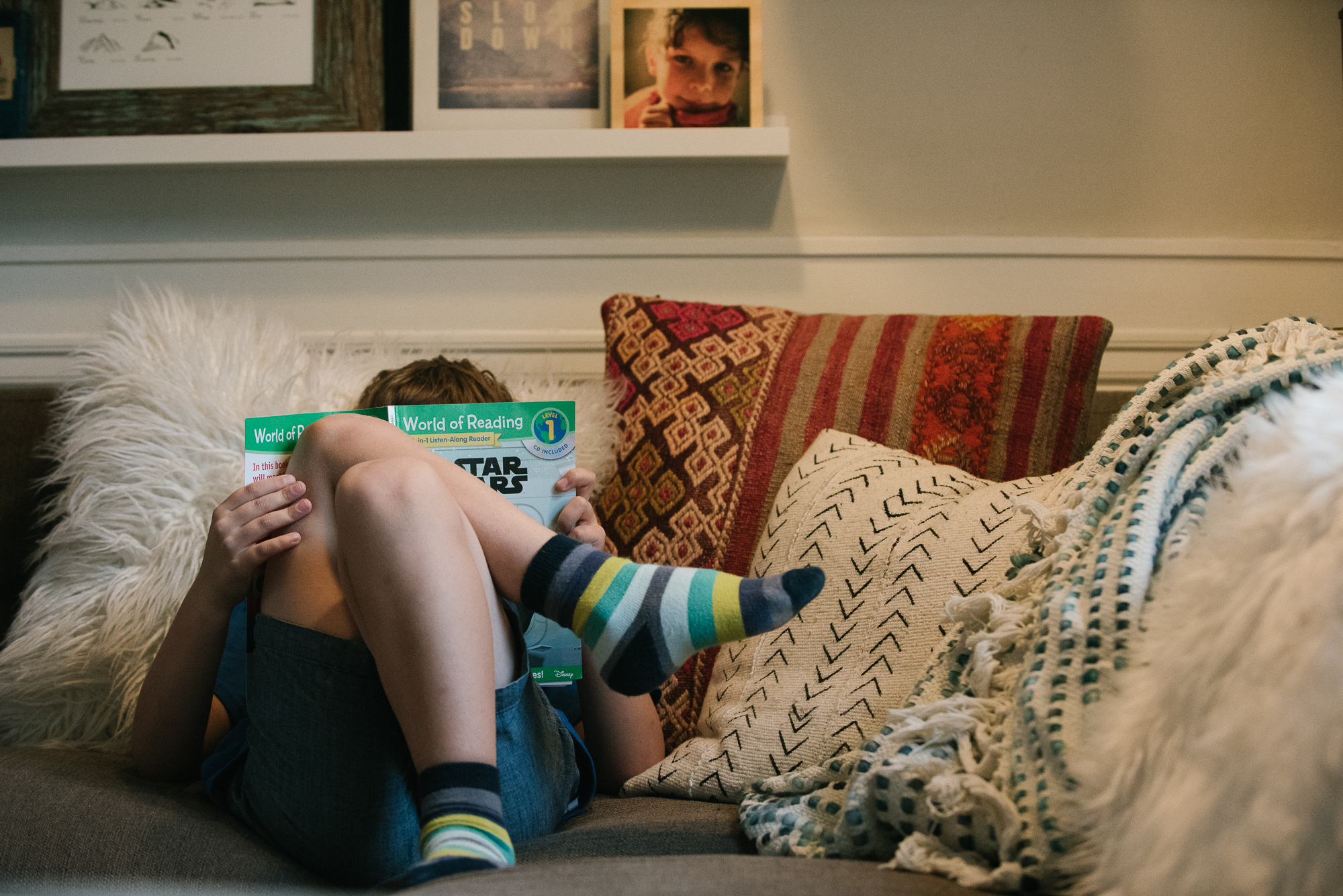 boy reading on couch -documentary family photography