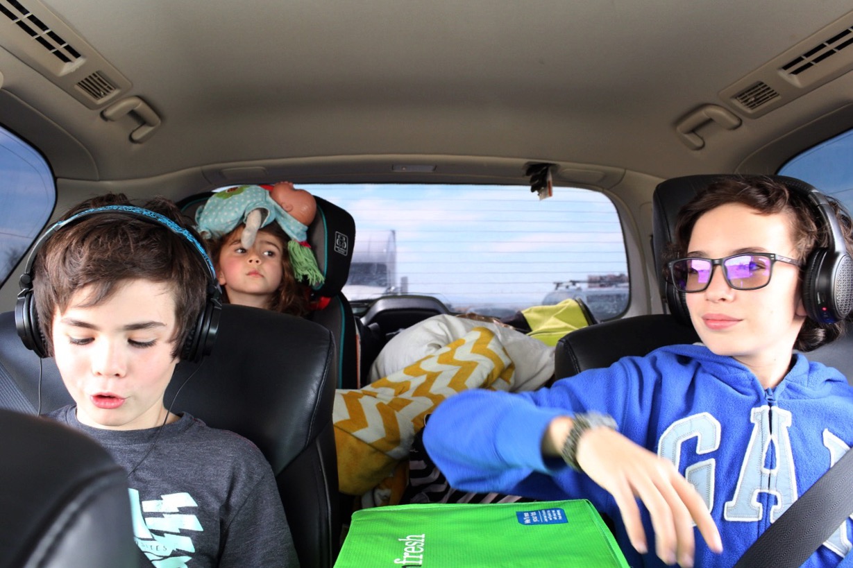 kids in car on trip - documentary family photography