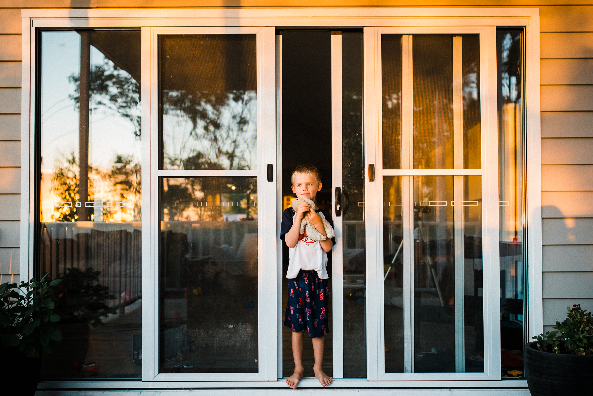 boy at door during sunset - documentary family photography