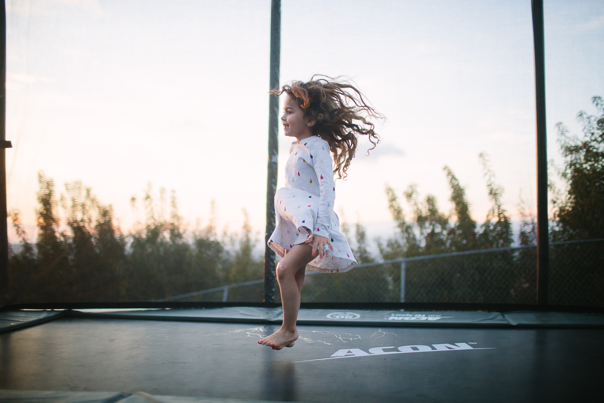 girl on trampoline - documentary family photography