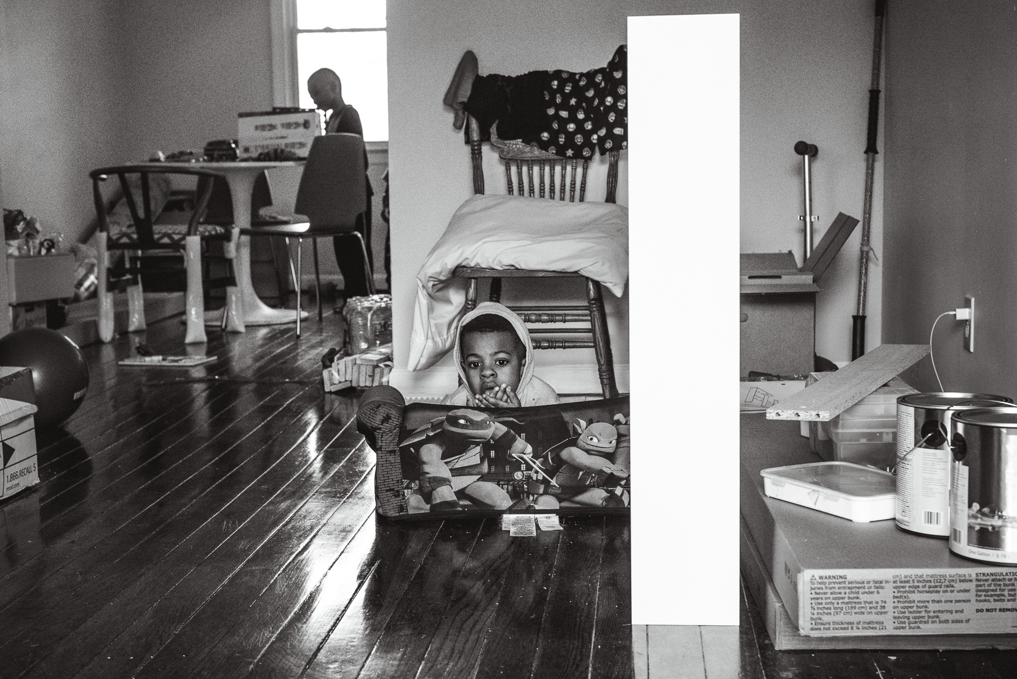 boy under chair - Documentary Family Photography