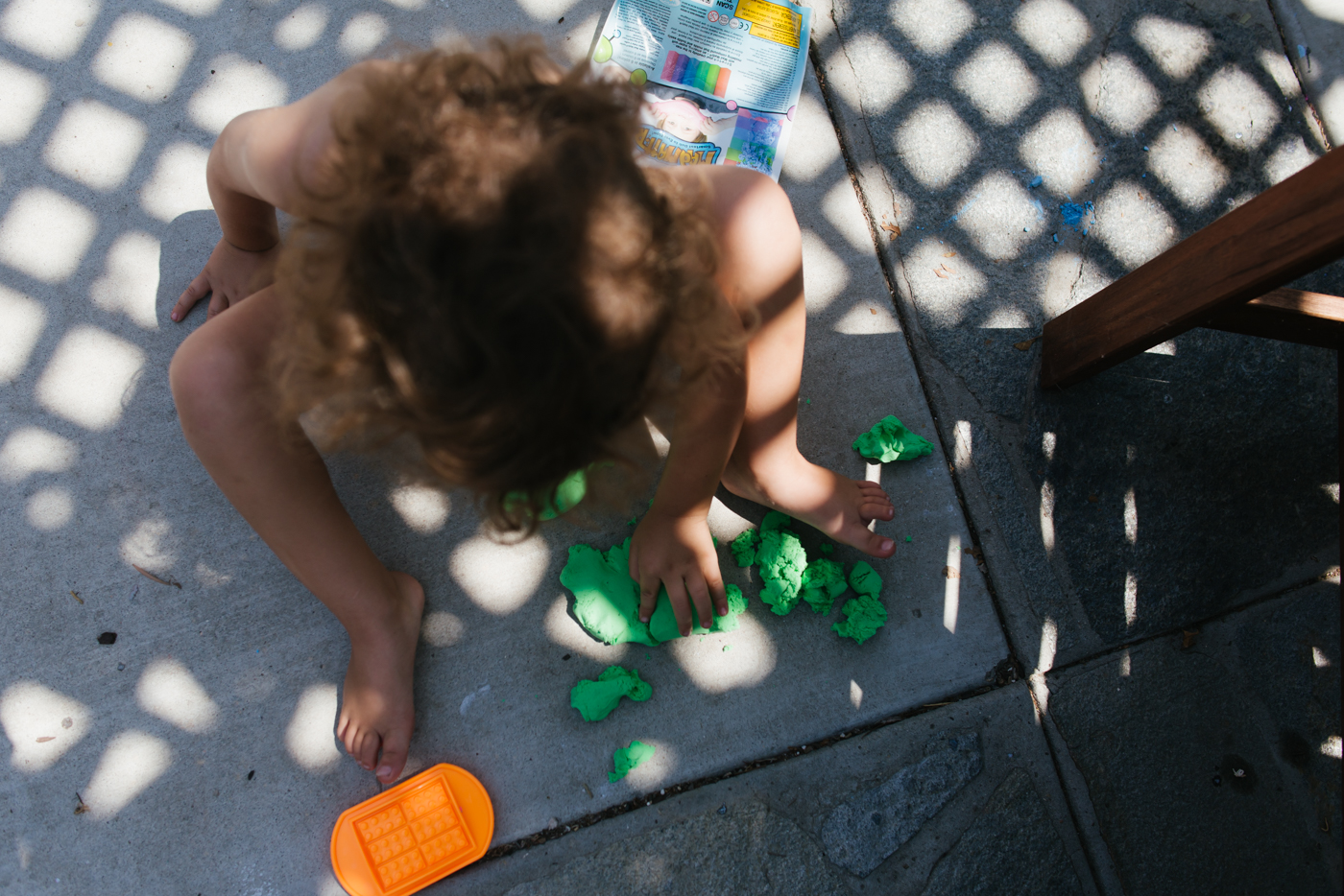 boy with playdoh on patio -Documentary Family Photography