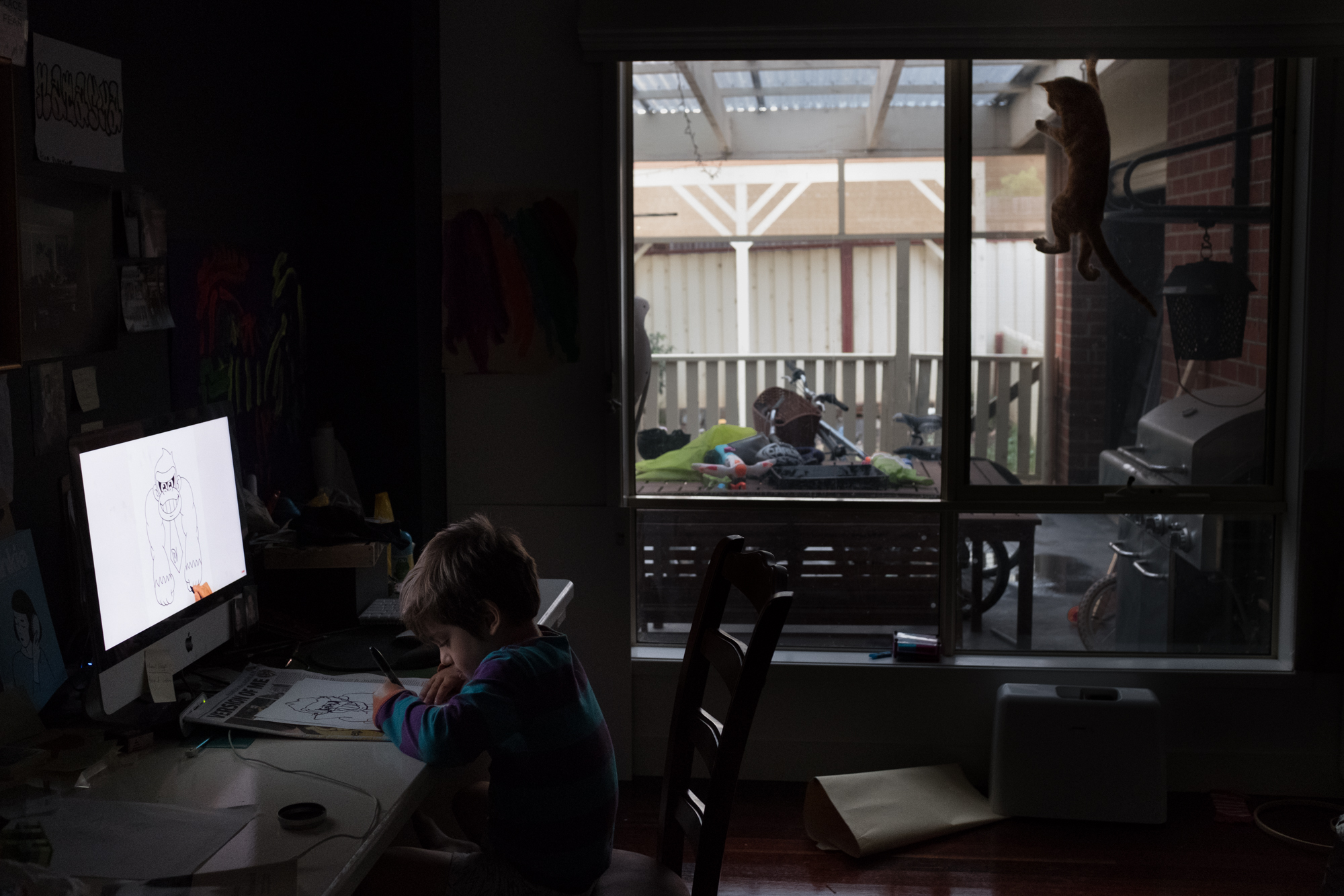 view out window with kid at table - documentary family photography