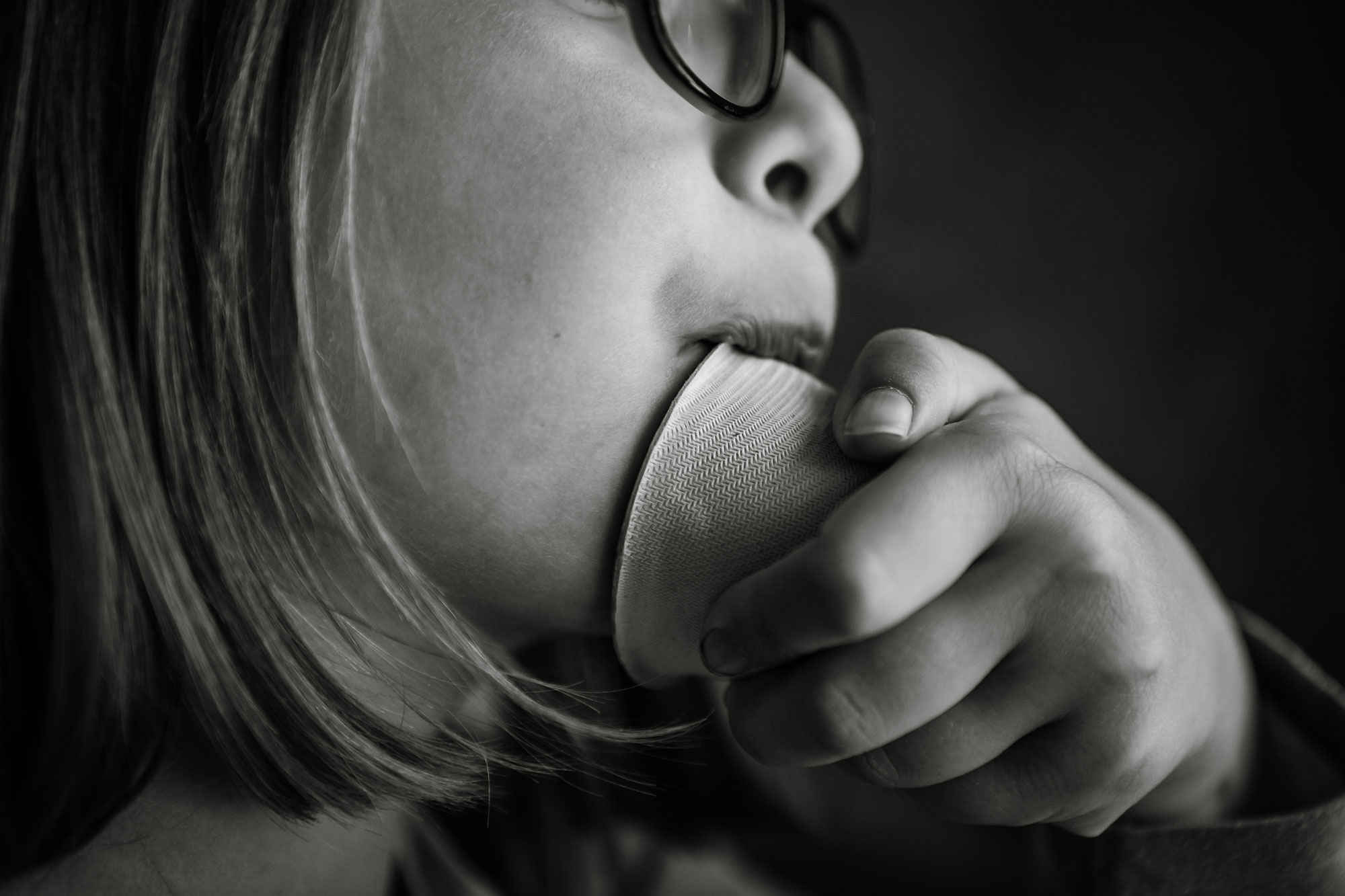 girl chewing on cup - documentary family photography
