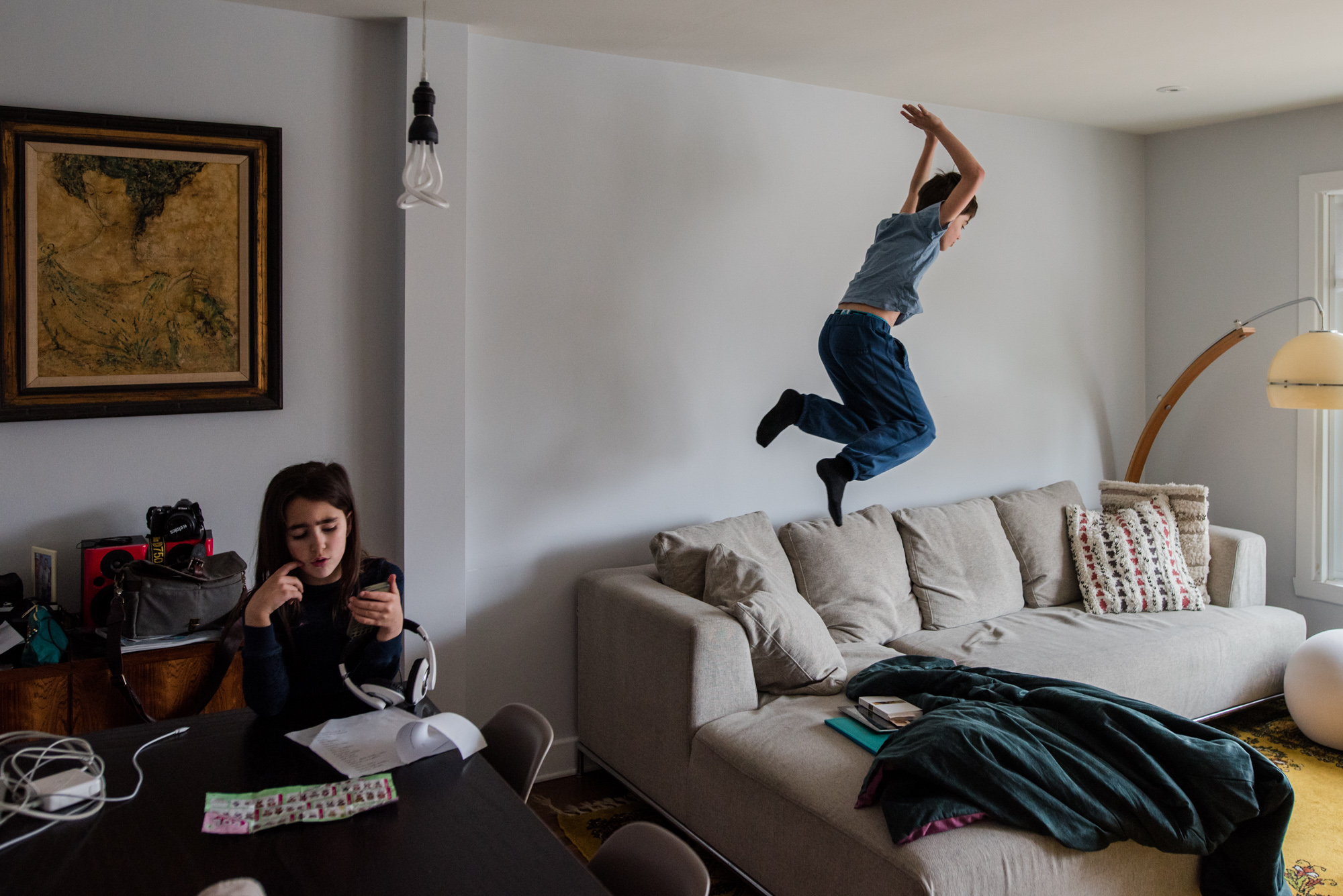 boy jumping on couch - documentary family photography