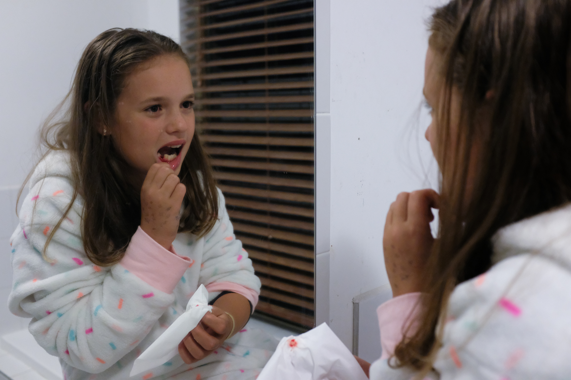 middle school girl looses tooth - documentary family photography