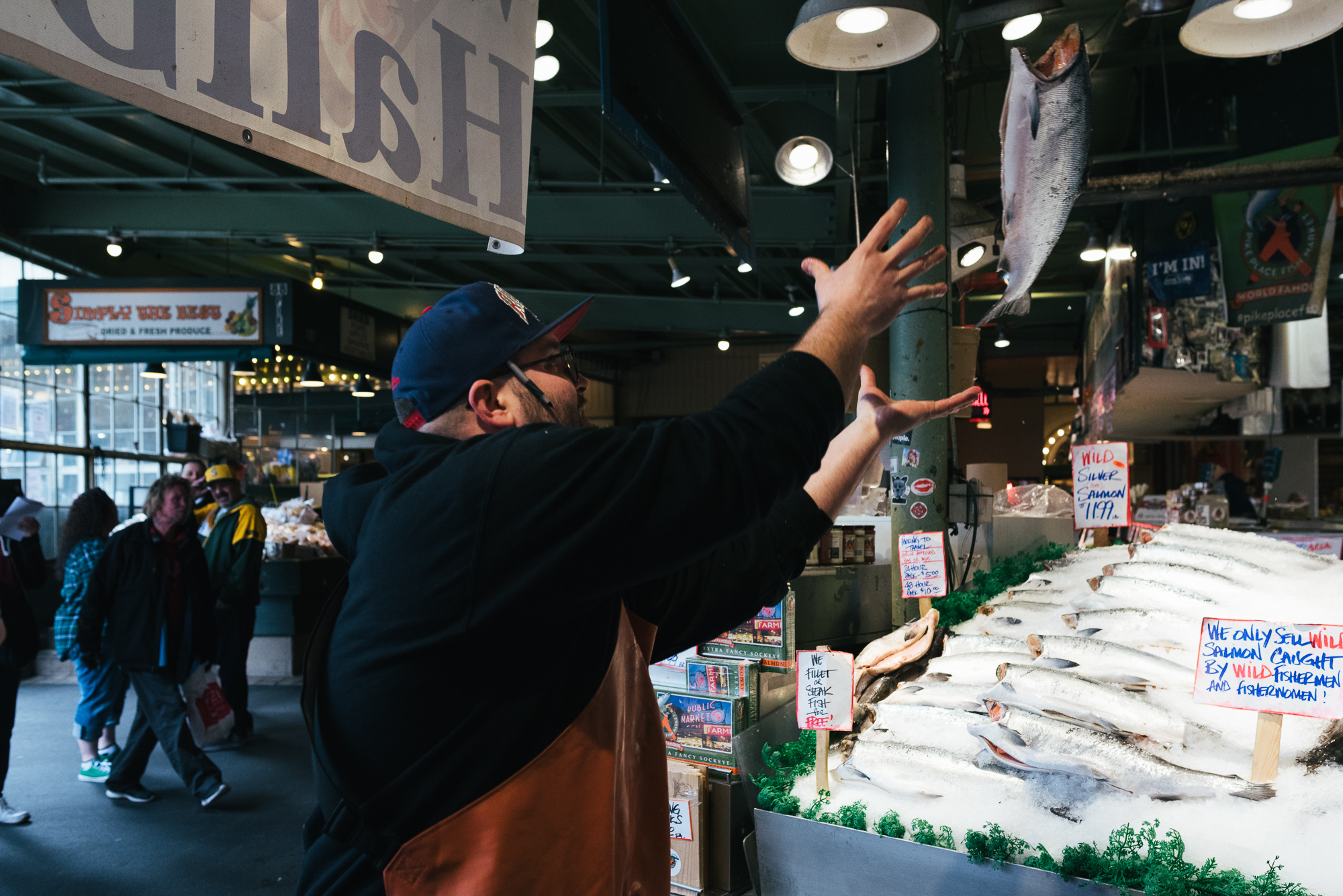 catching fish in Seattle market - documentary family photography