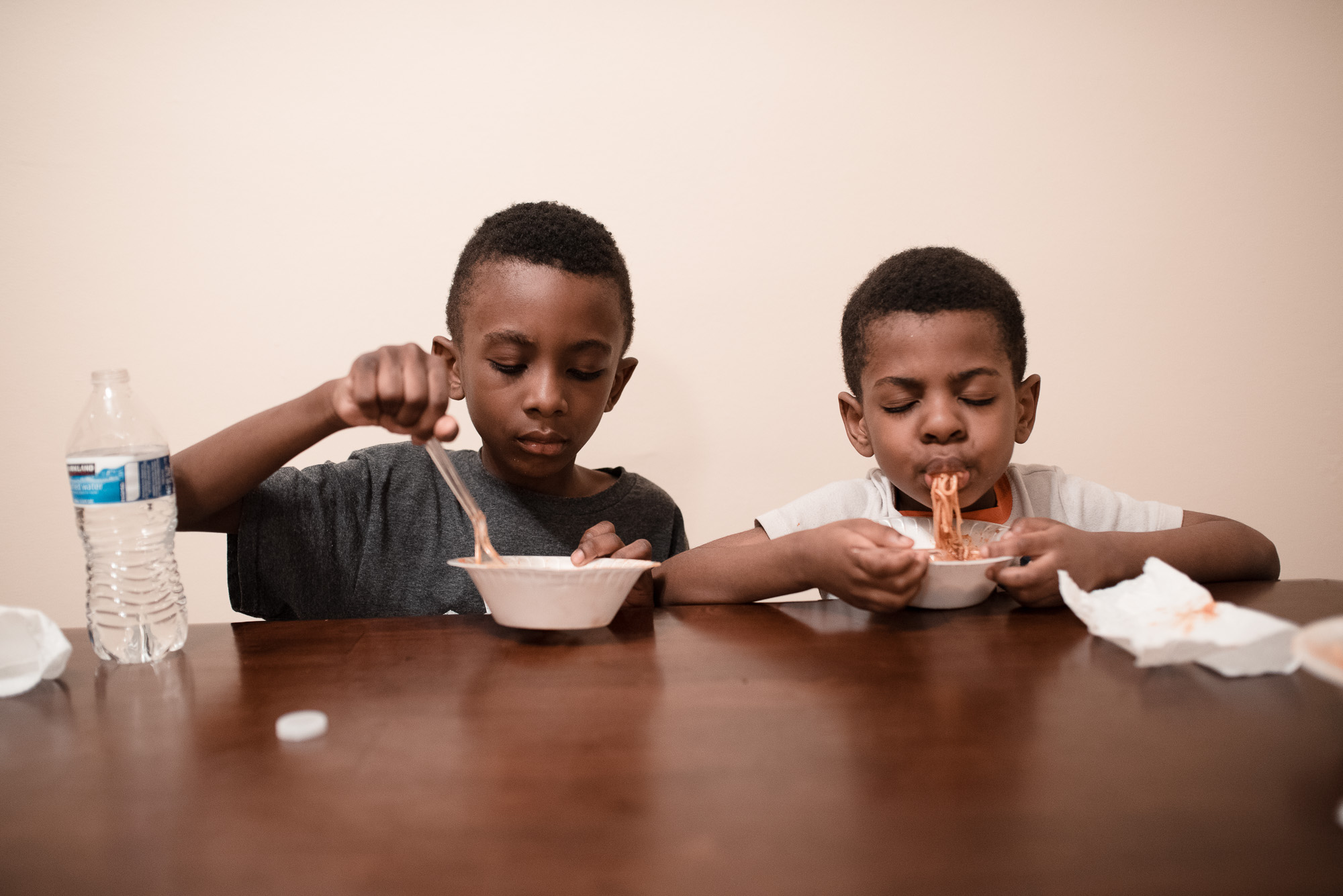 boys eating pasta - documentary family photography