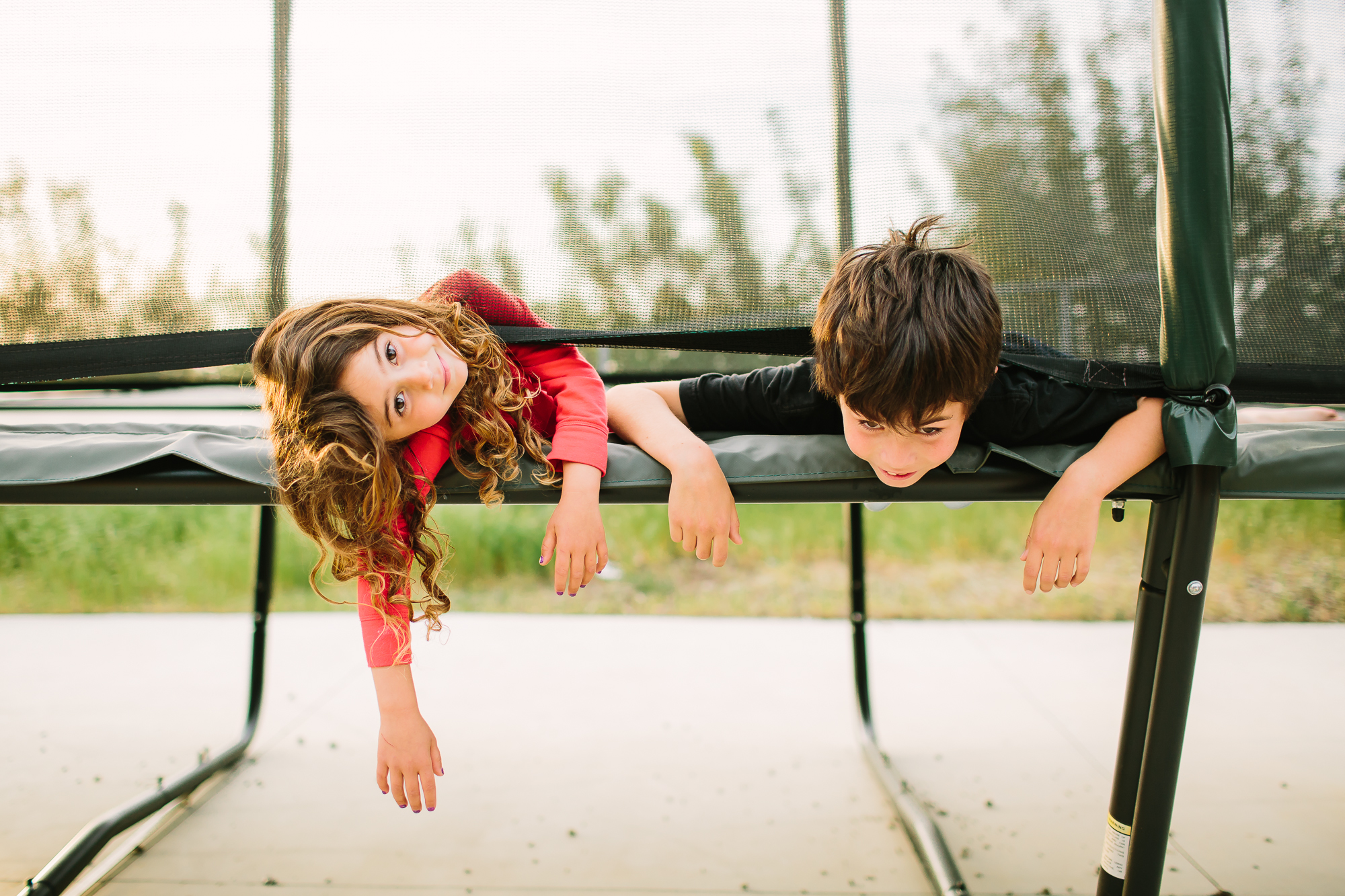 kids lounge on trampoline - documentary family photography