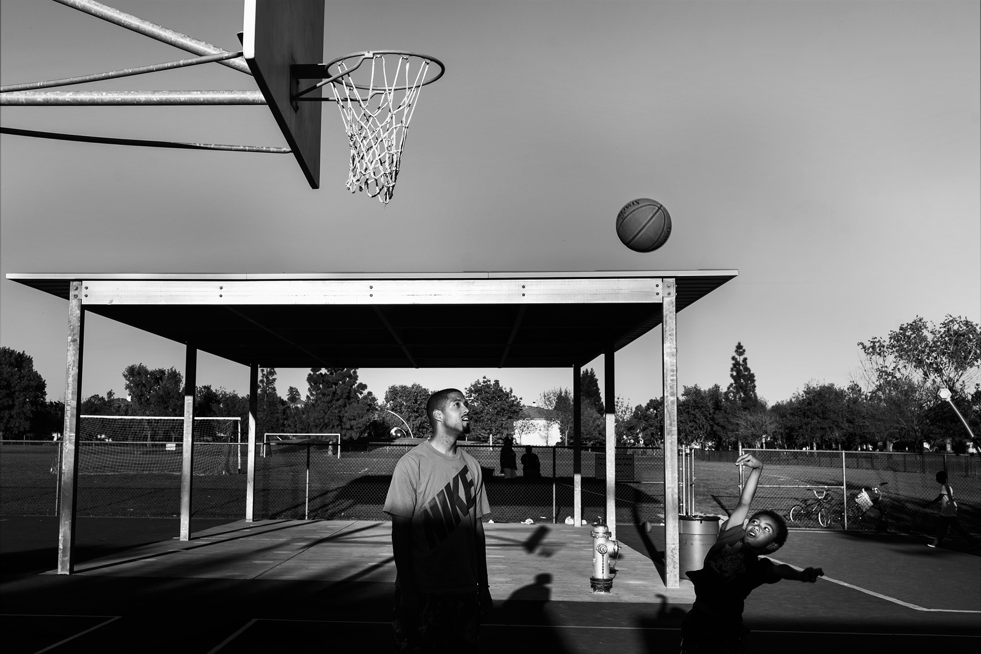 father and son play basketball - documentary family photography