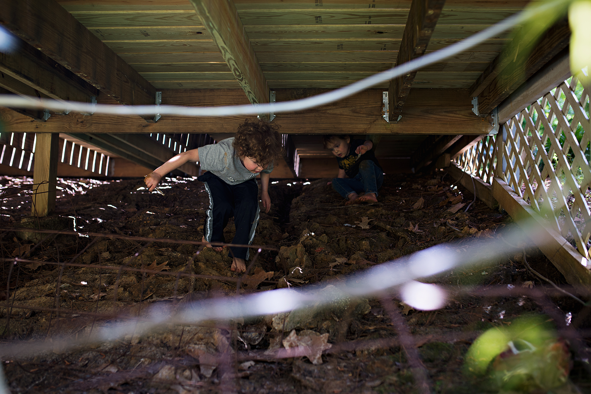 boy under porch - documentary family photography