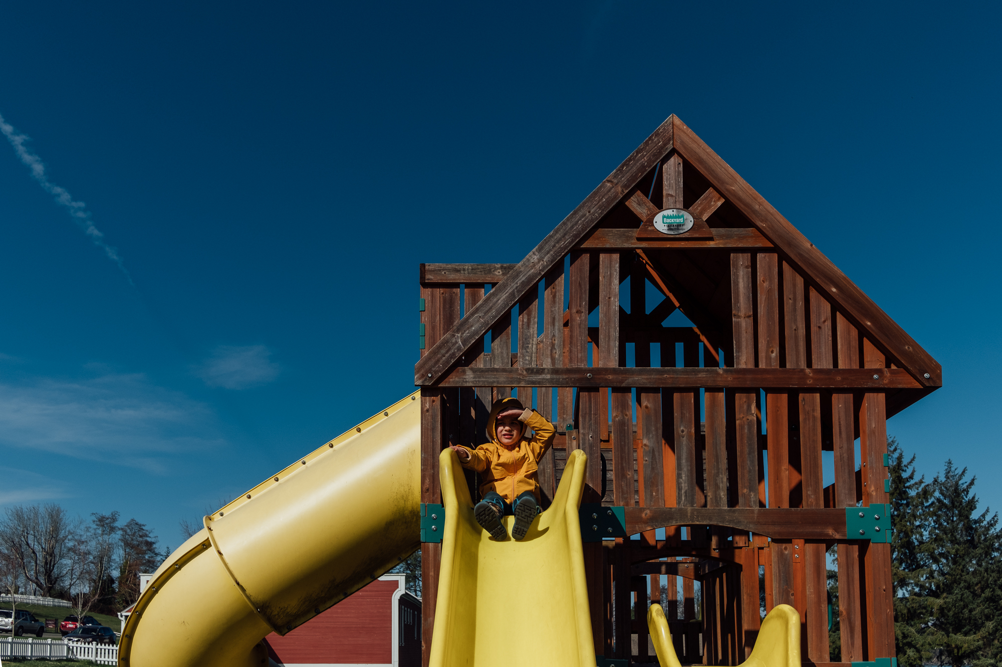 boy at top of slide - documentary family photography