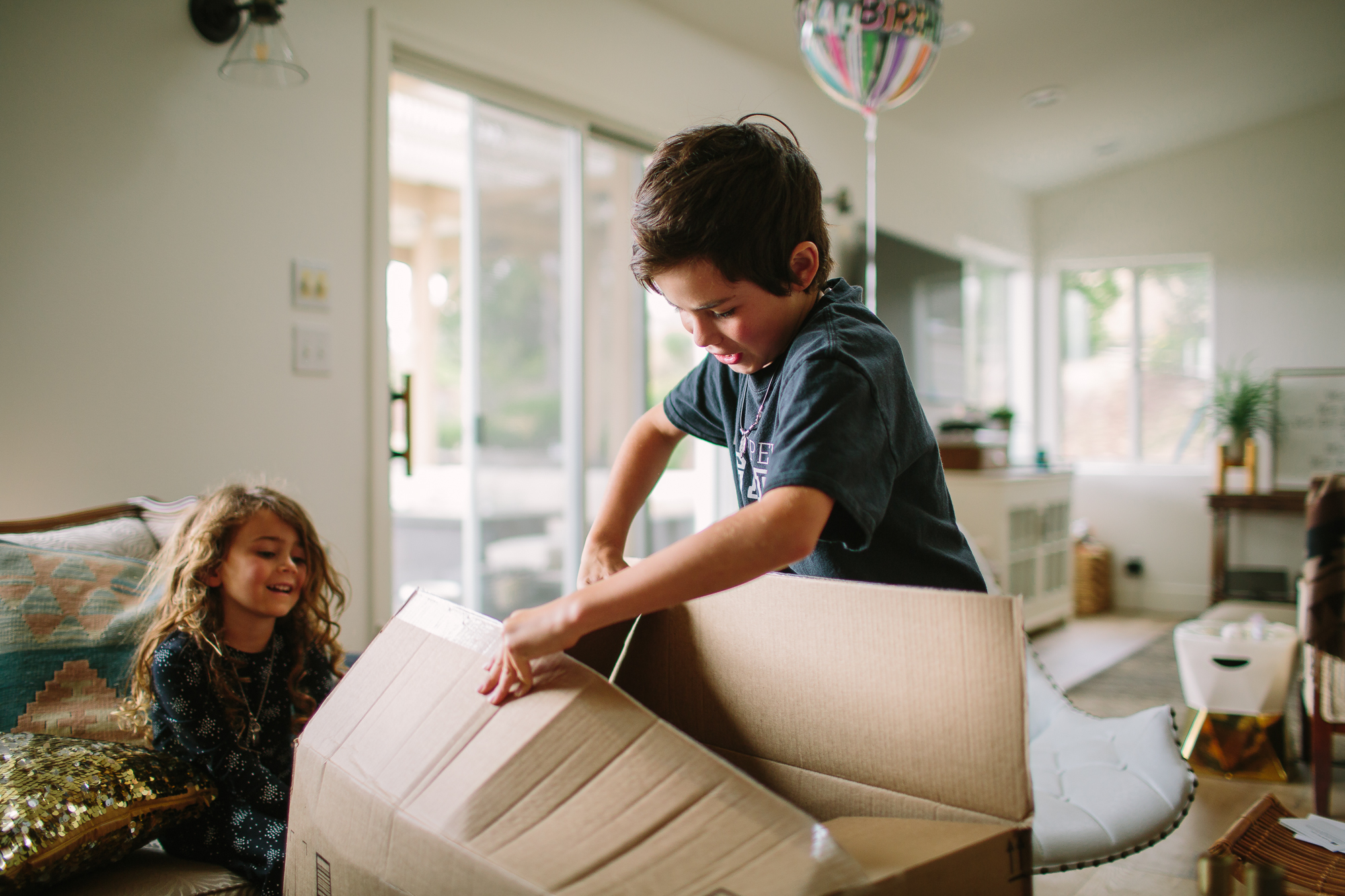 boy opening box - documentary family photography