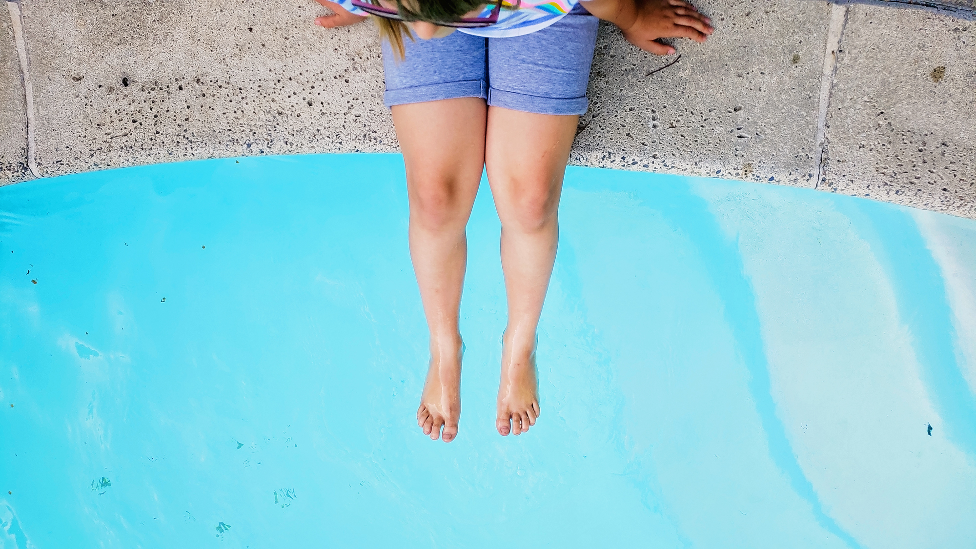 girls feet in pool - documentary family photography