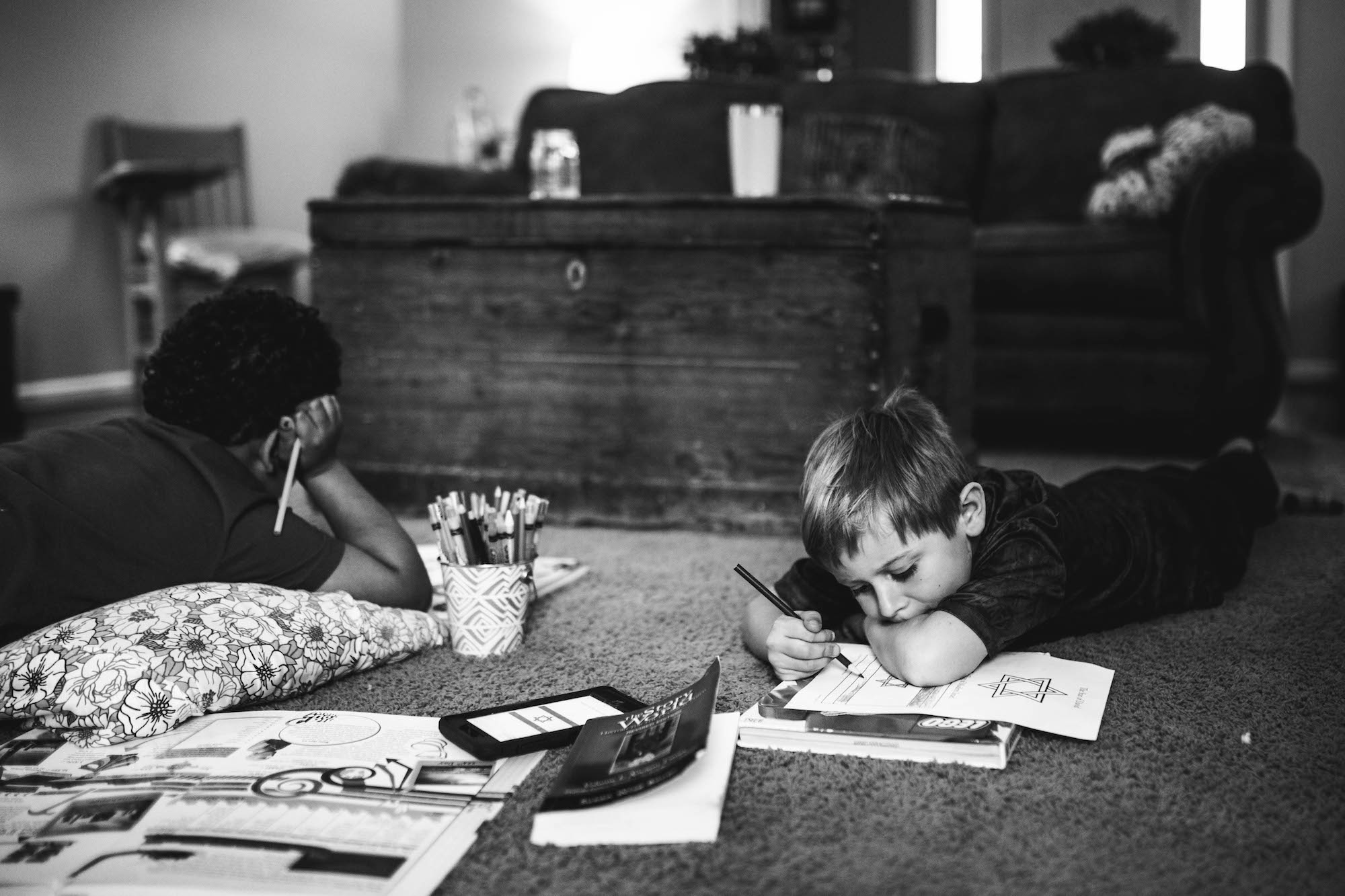 kids on floor with homework - documentary family photography