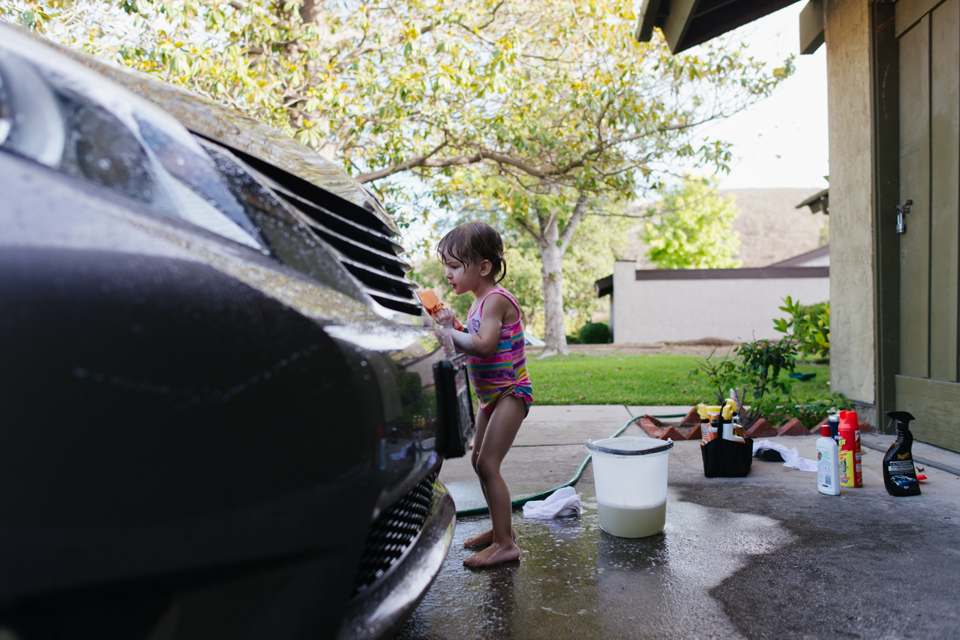 girl washing car - documentary family photography