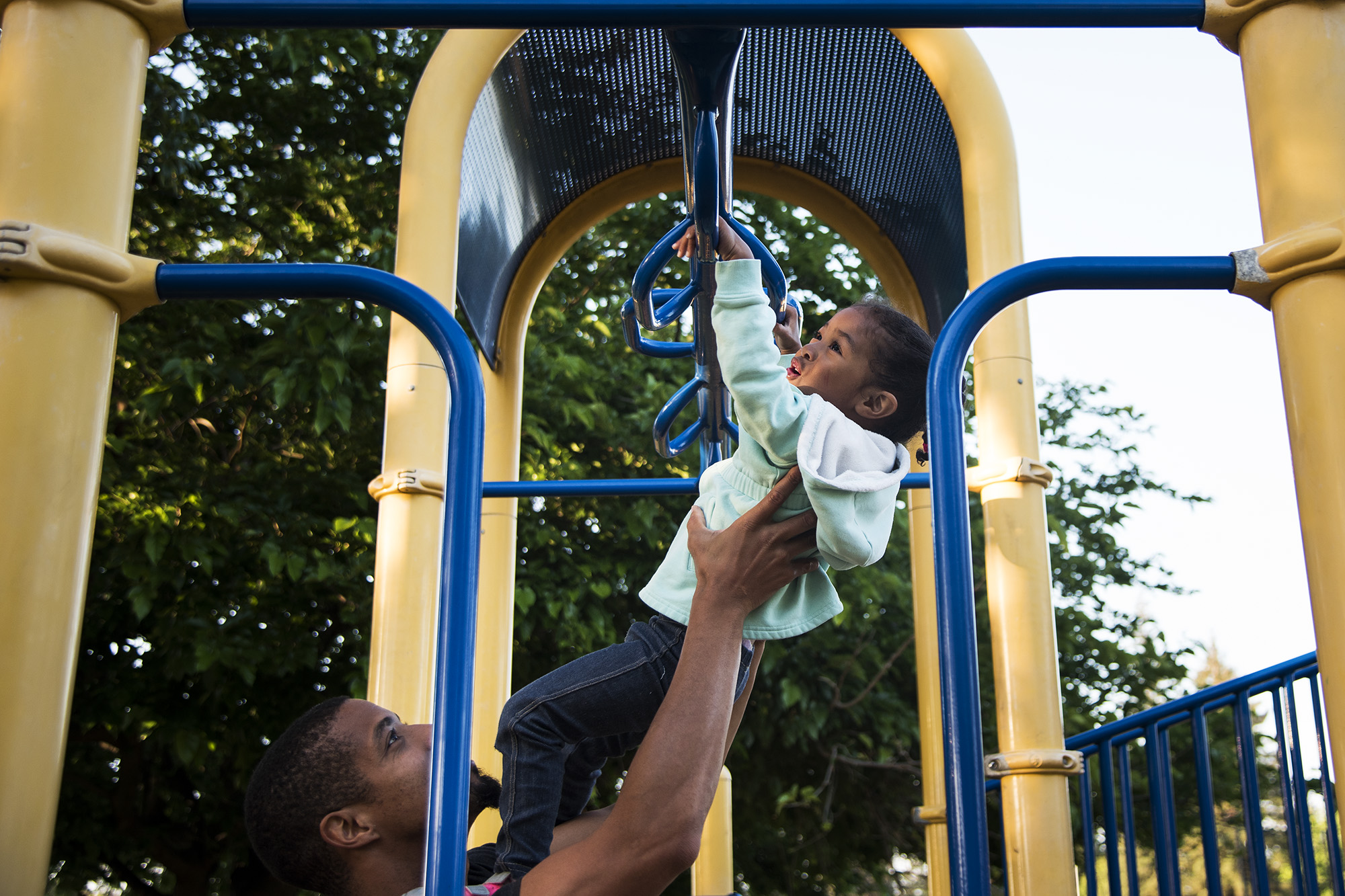 father with daughter on playground - Documentary family photography