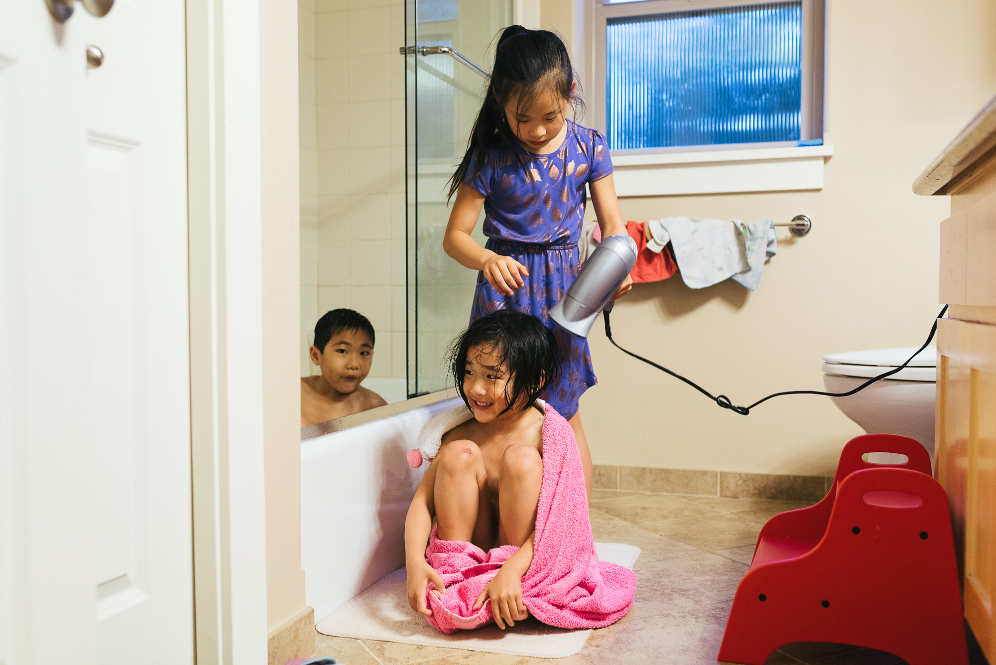 sister blowdrying hair - Documentary family photography