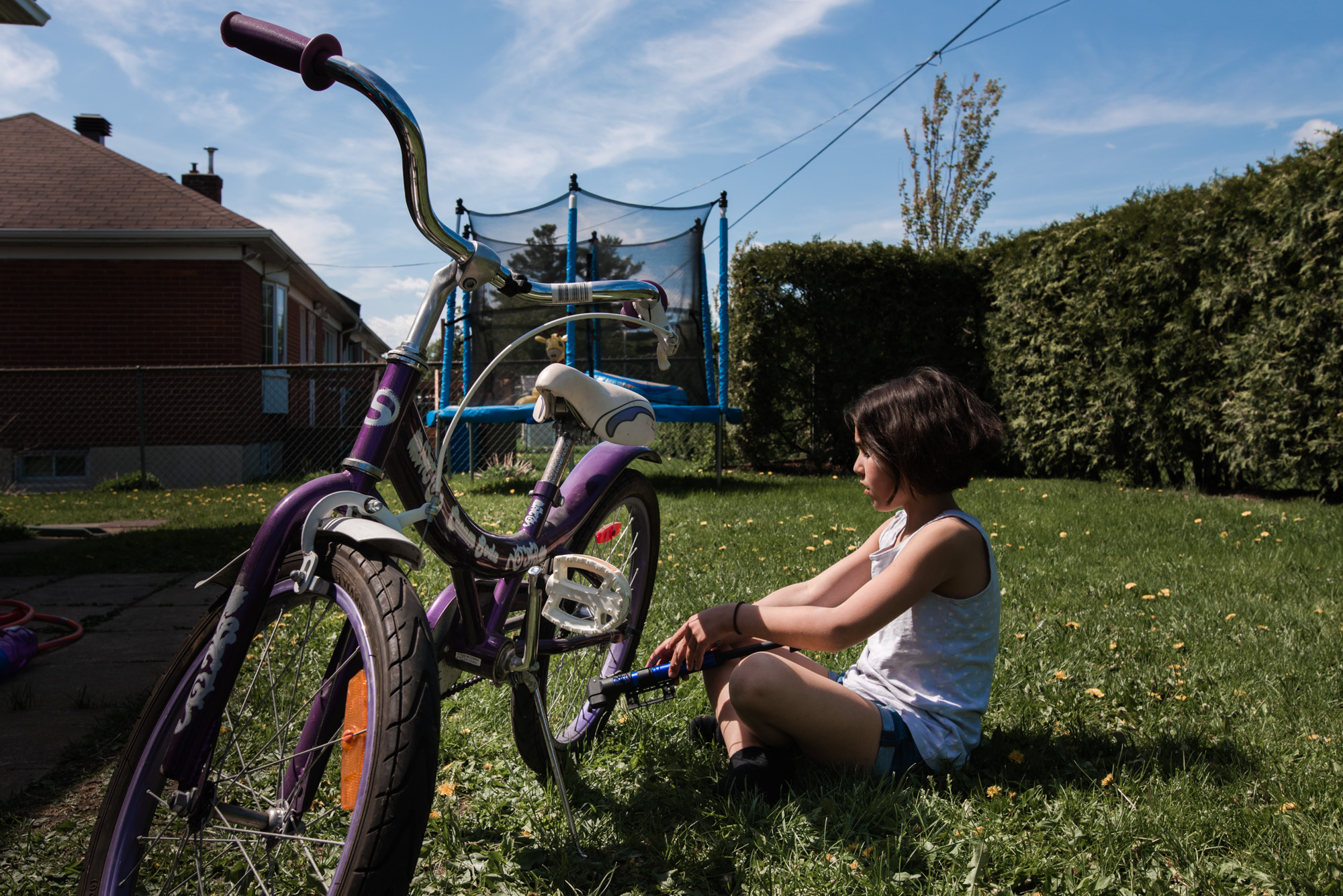 girl sits with bike - Documentary family photography