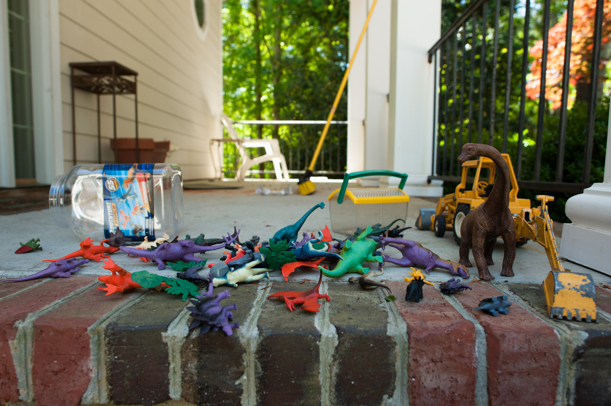 dinosaur toys on patio - Documentary family photography