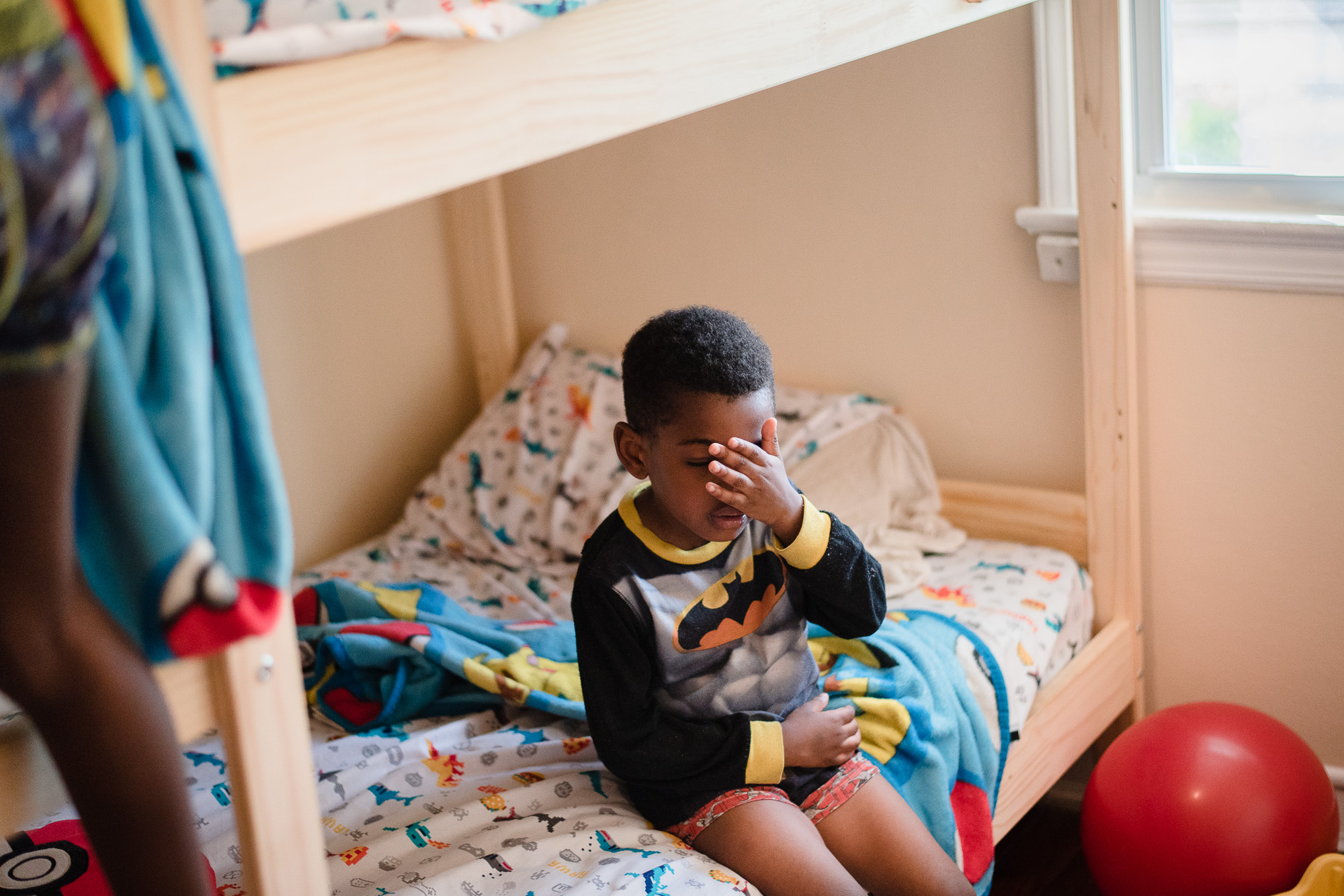 boy hiding face -documentary family photography