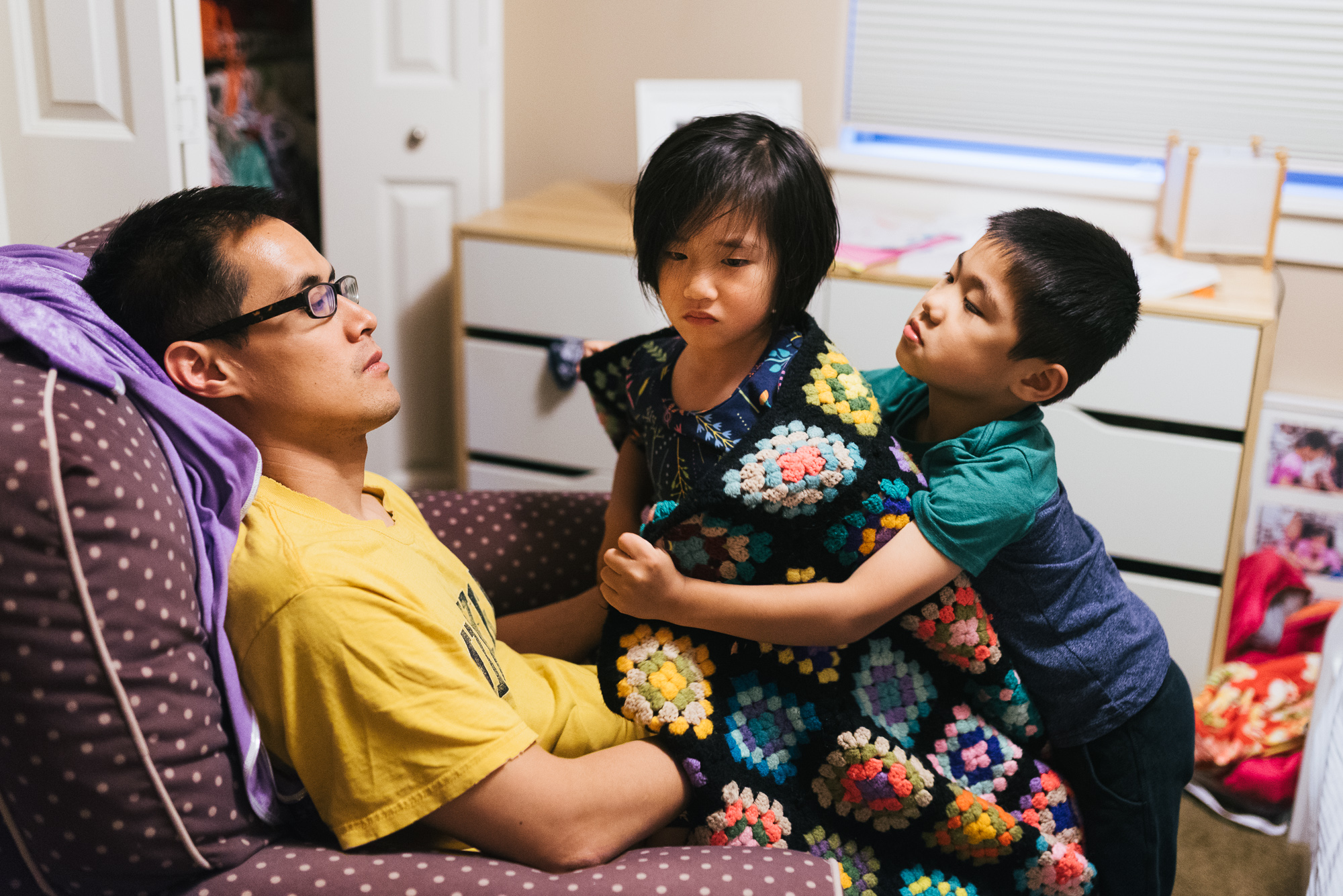 kids snuggling with father - documentary family photography