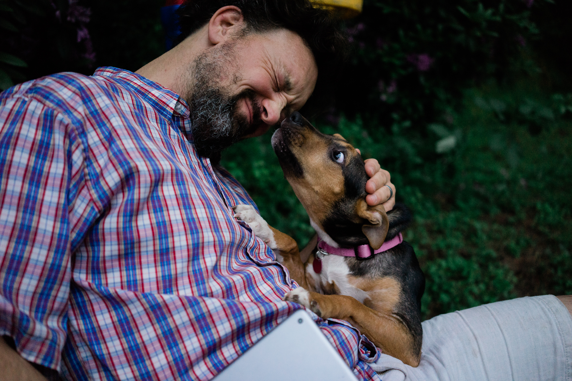 man snuggling puppy - documentary family photography