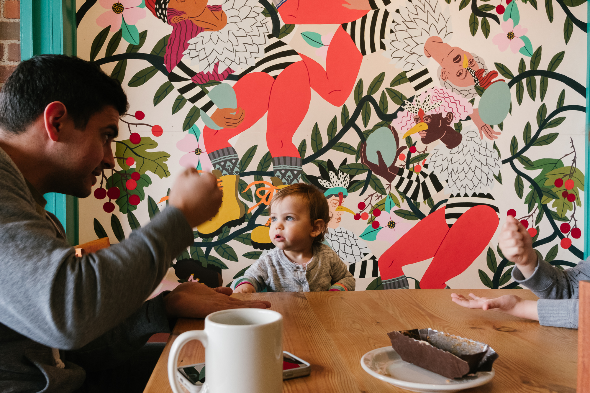 baby girl in front of mural - Documentary Family Photography