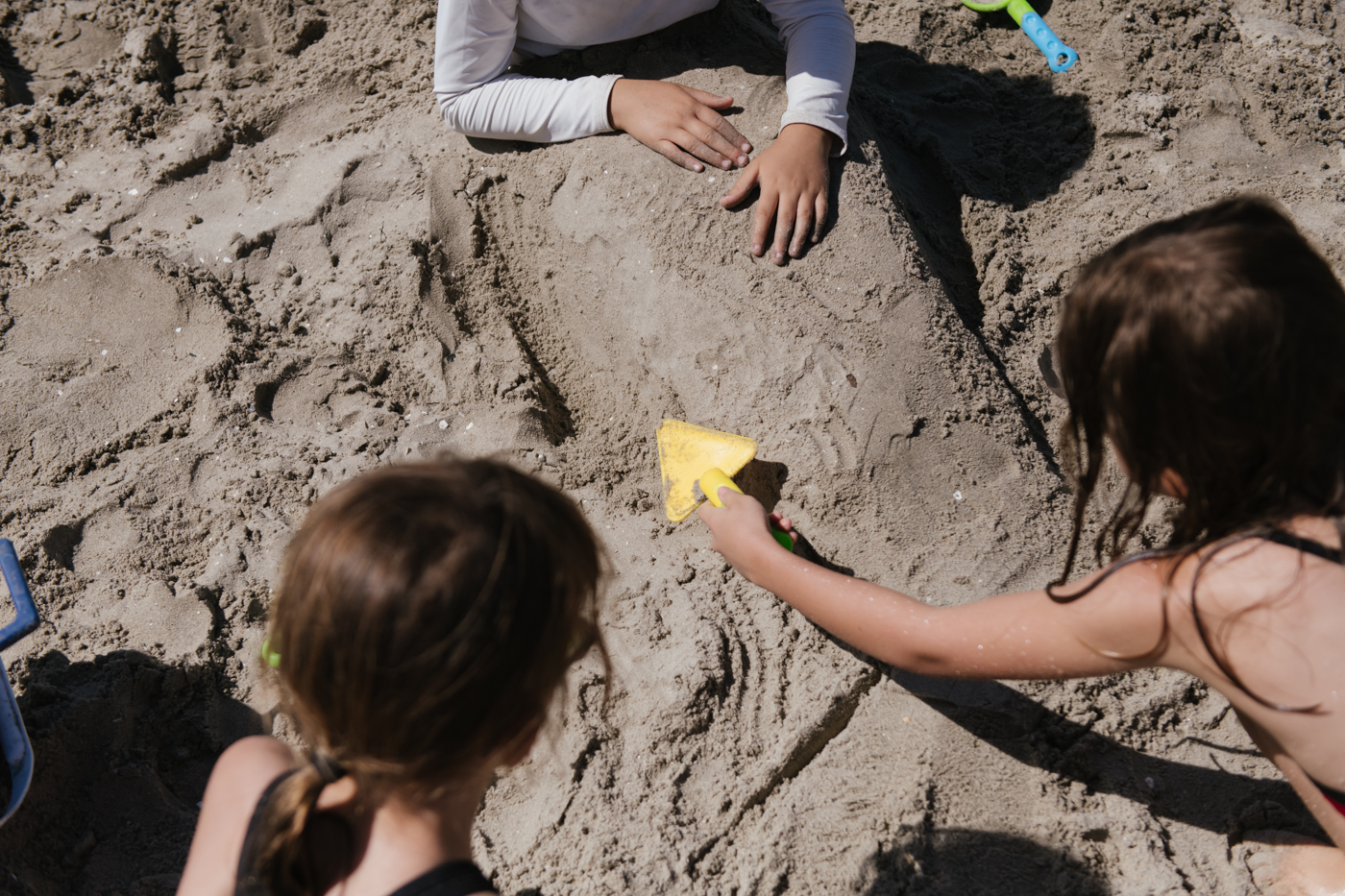 kids playing in sand on beach - Documentary Family Photography