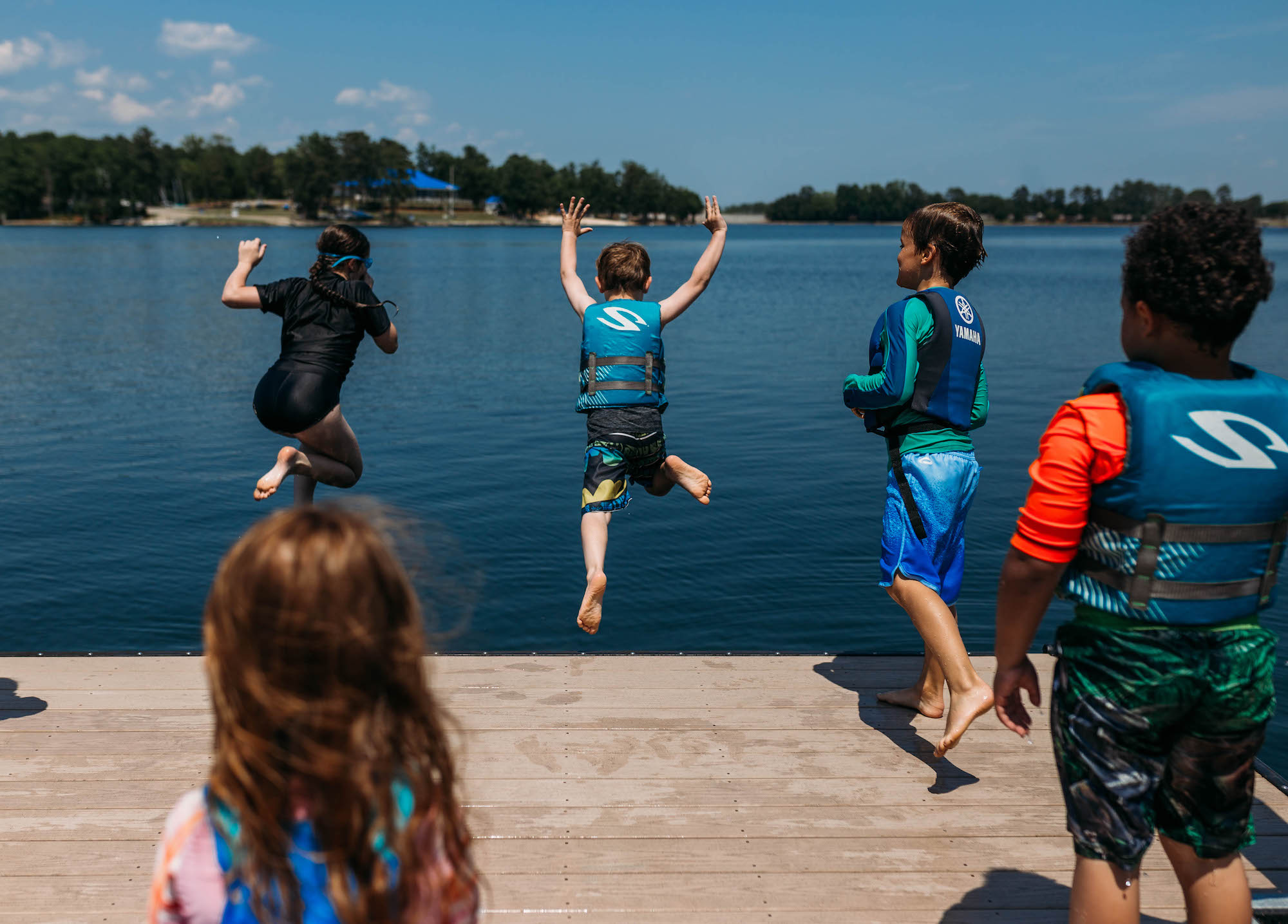 kids jumping off dock - documentary family photography