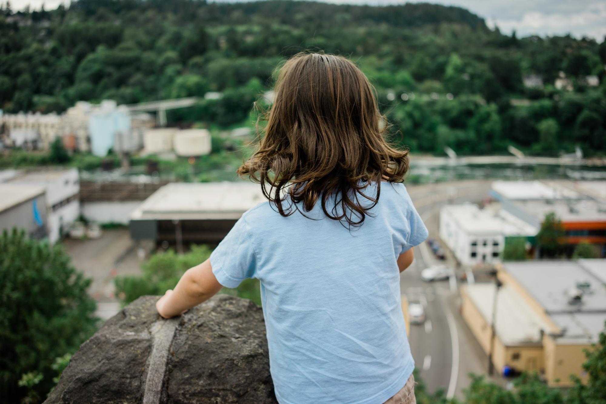 child peering over roof - documentary family photography