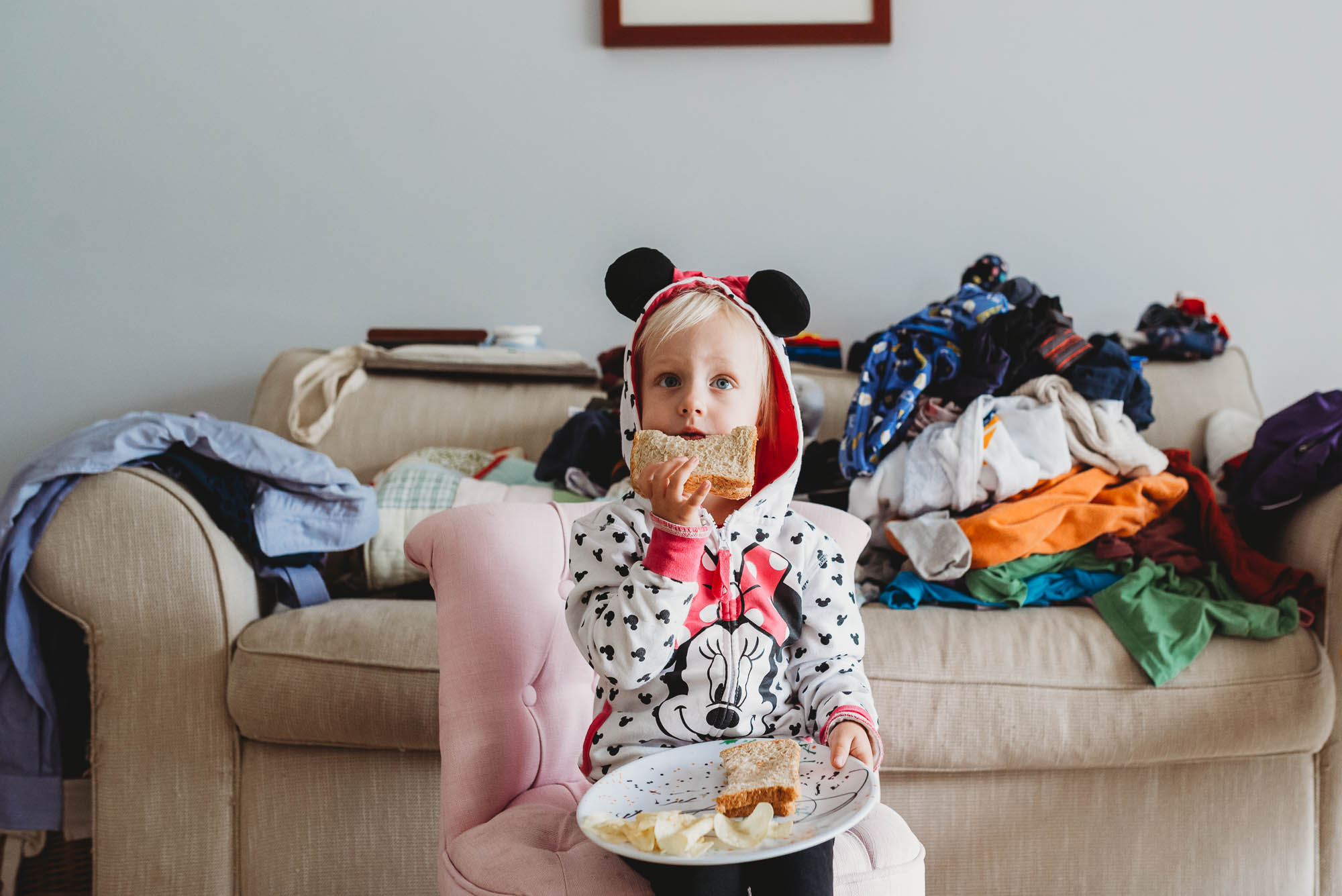 girl eating in minnie mouse hoodie - documentary family photography