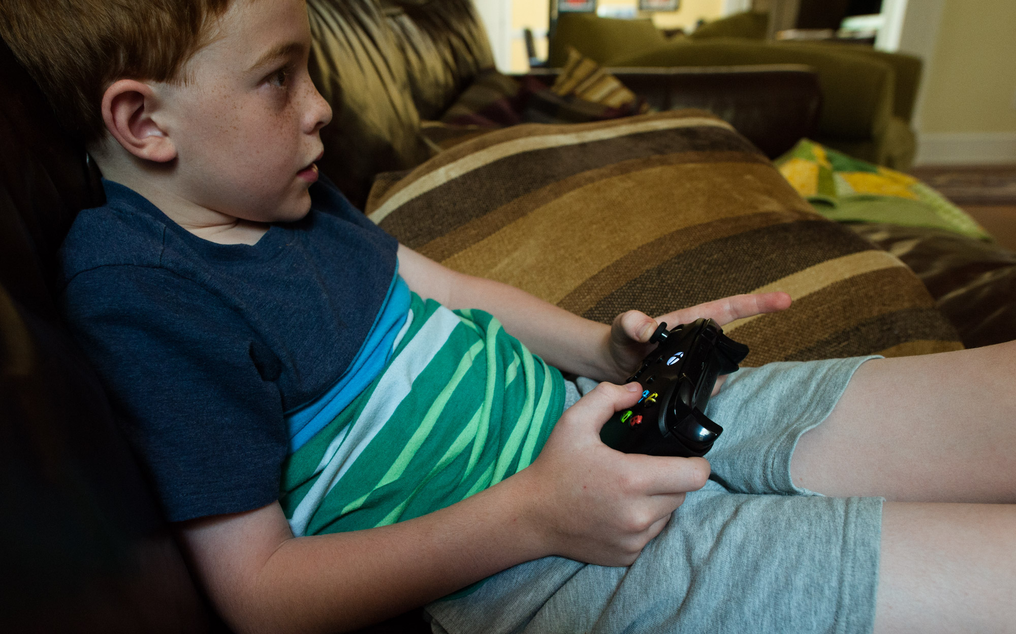 boy plays video games - documentary family photography