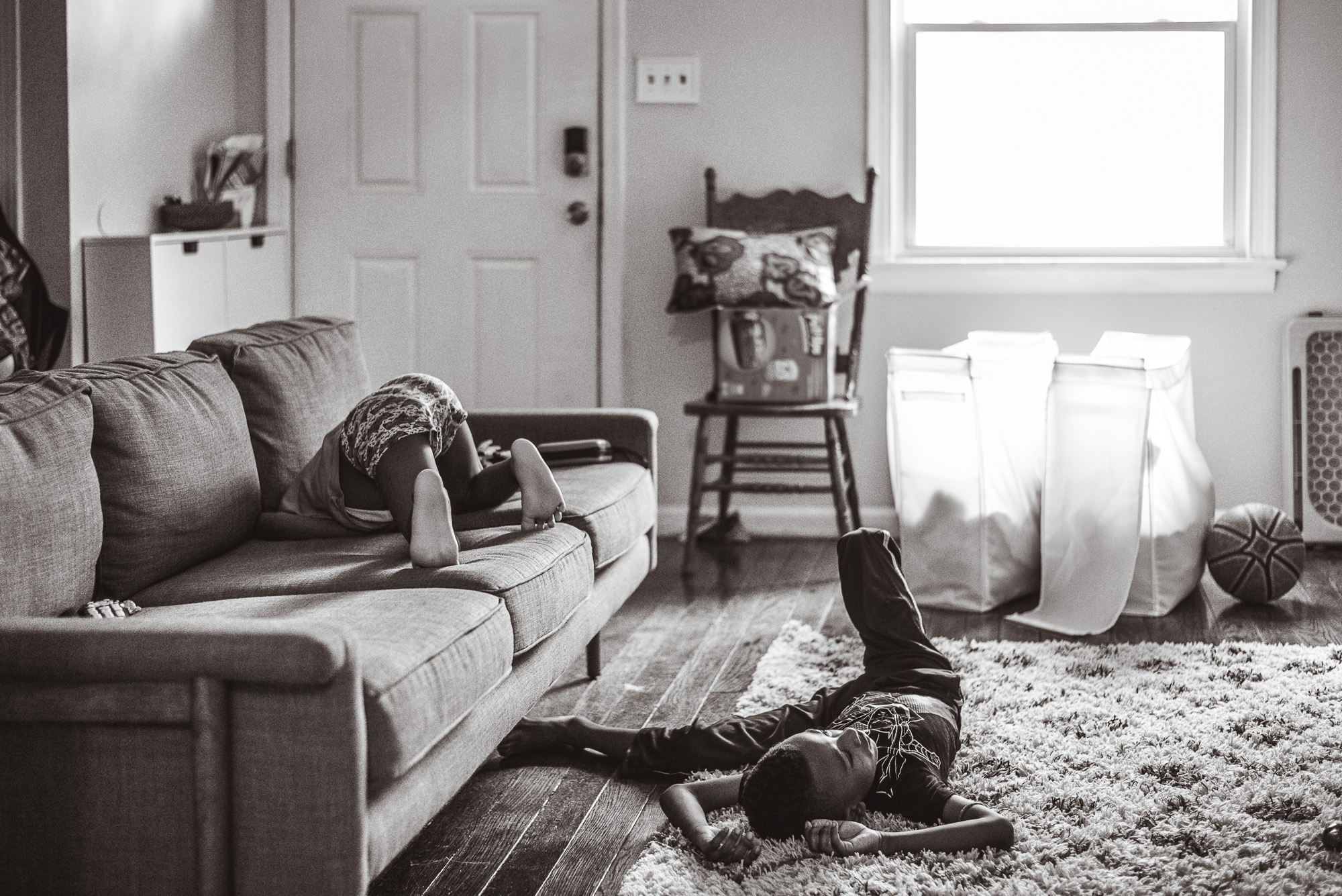 kids rolling around living room - documentary family photography