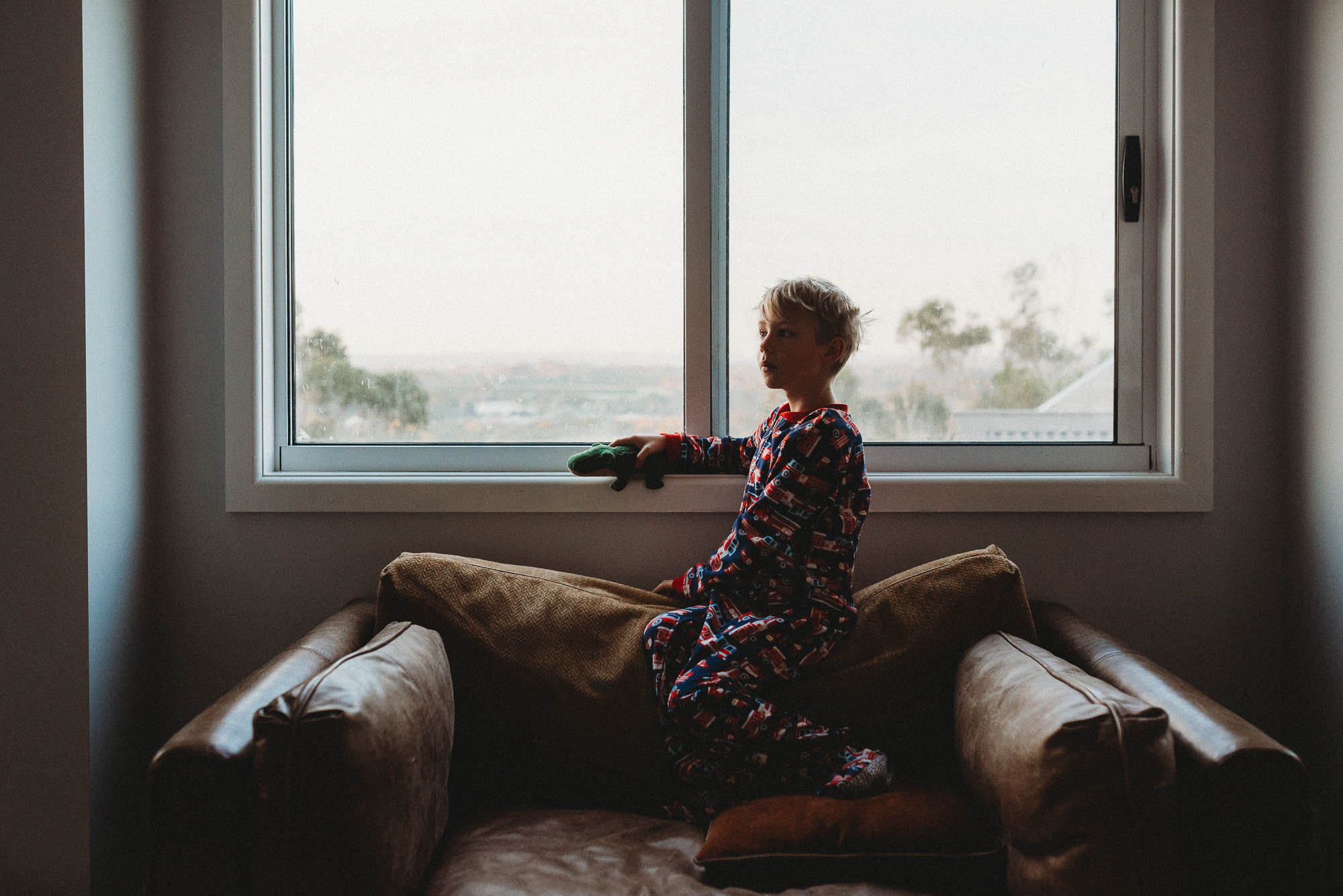 boy on chair near window - documentary family photography