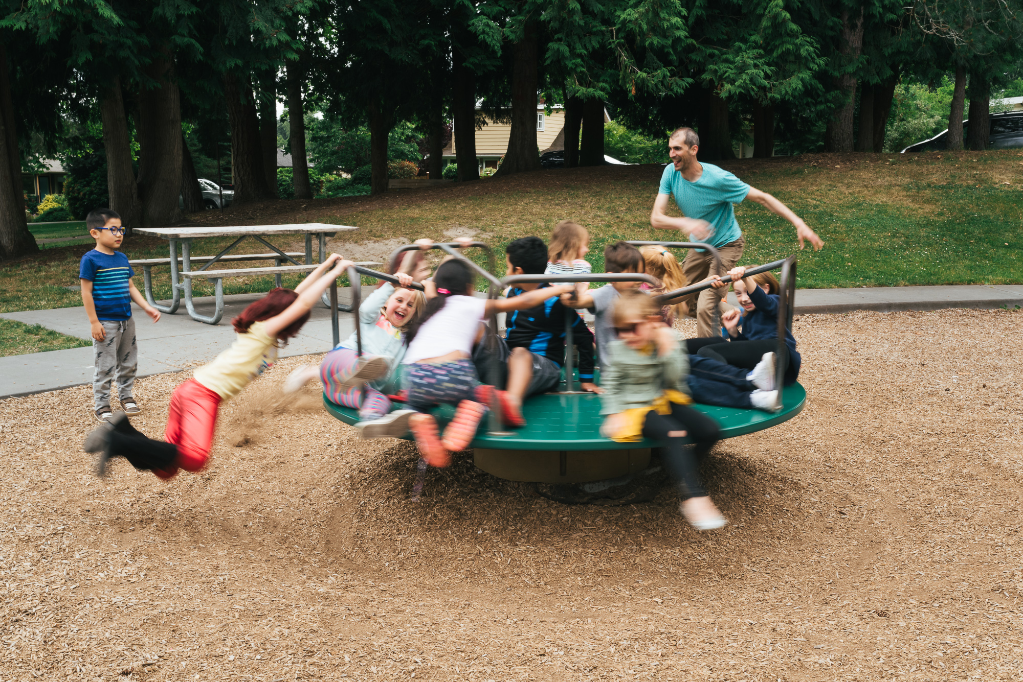 kids on merry go round - documentary family photography