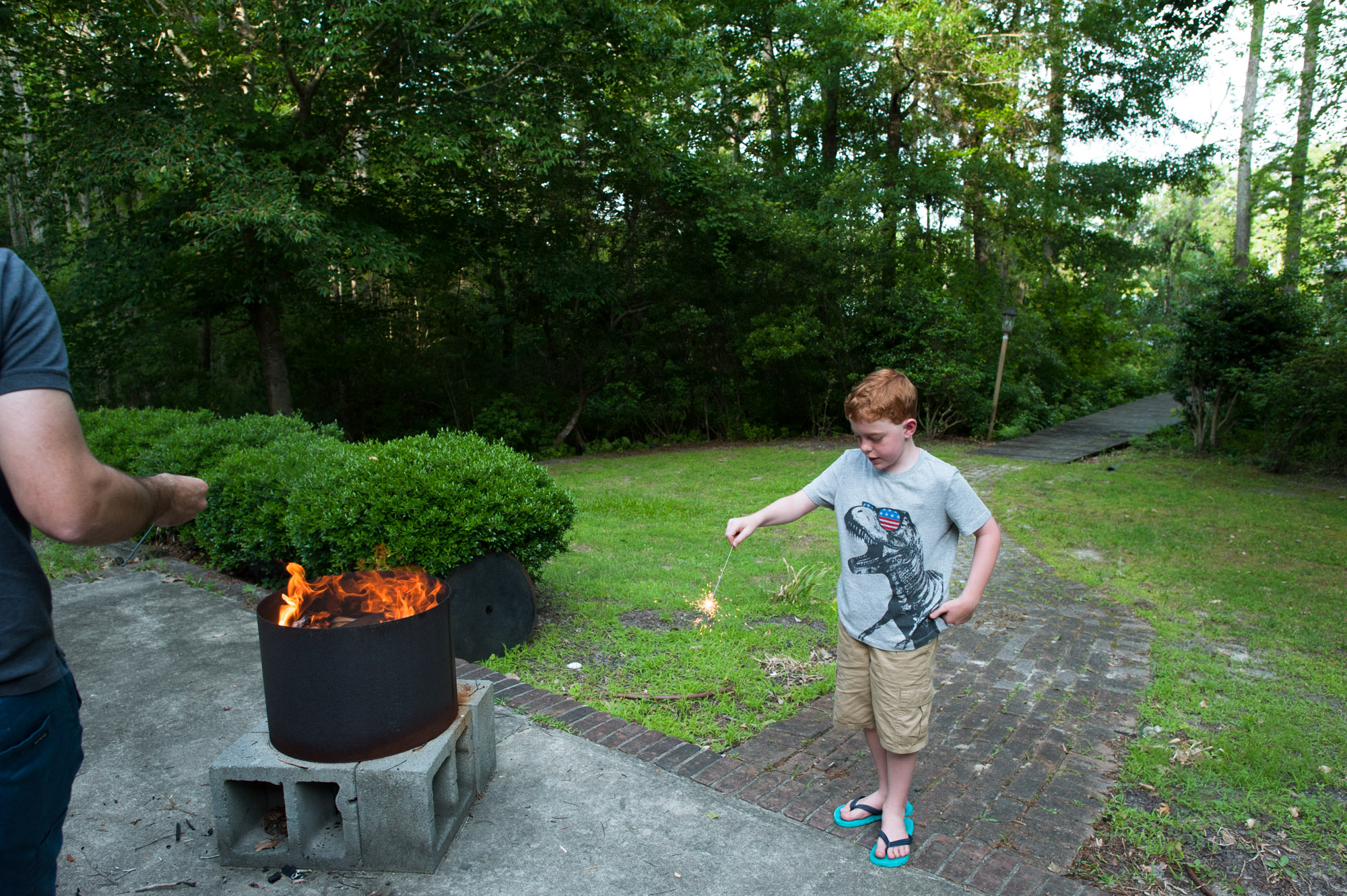 boy near fire pitt - documentary family photography