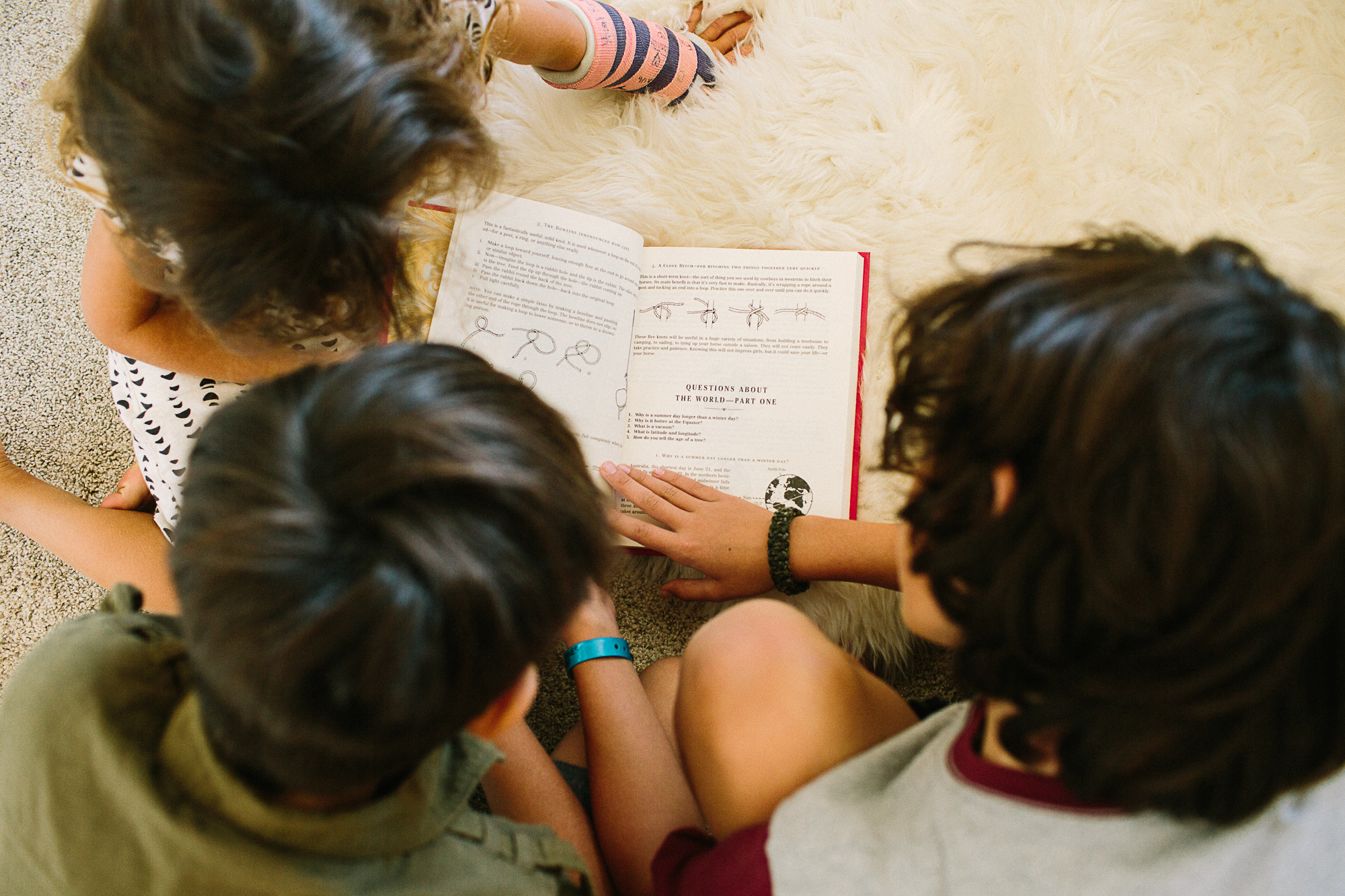 kids looking over book - documentary family photography