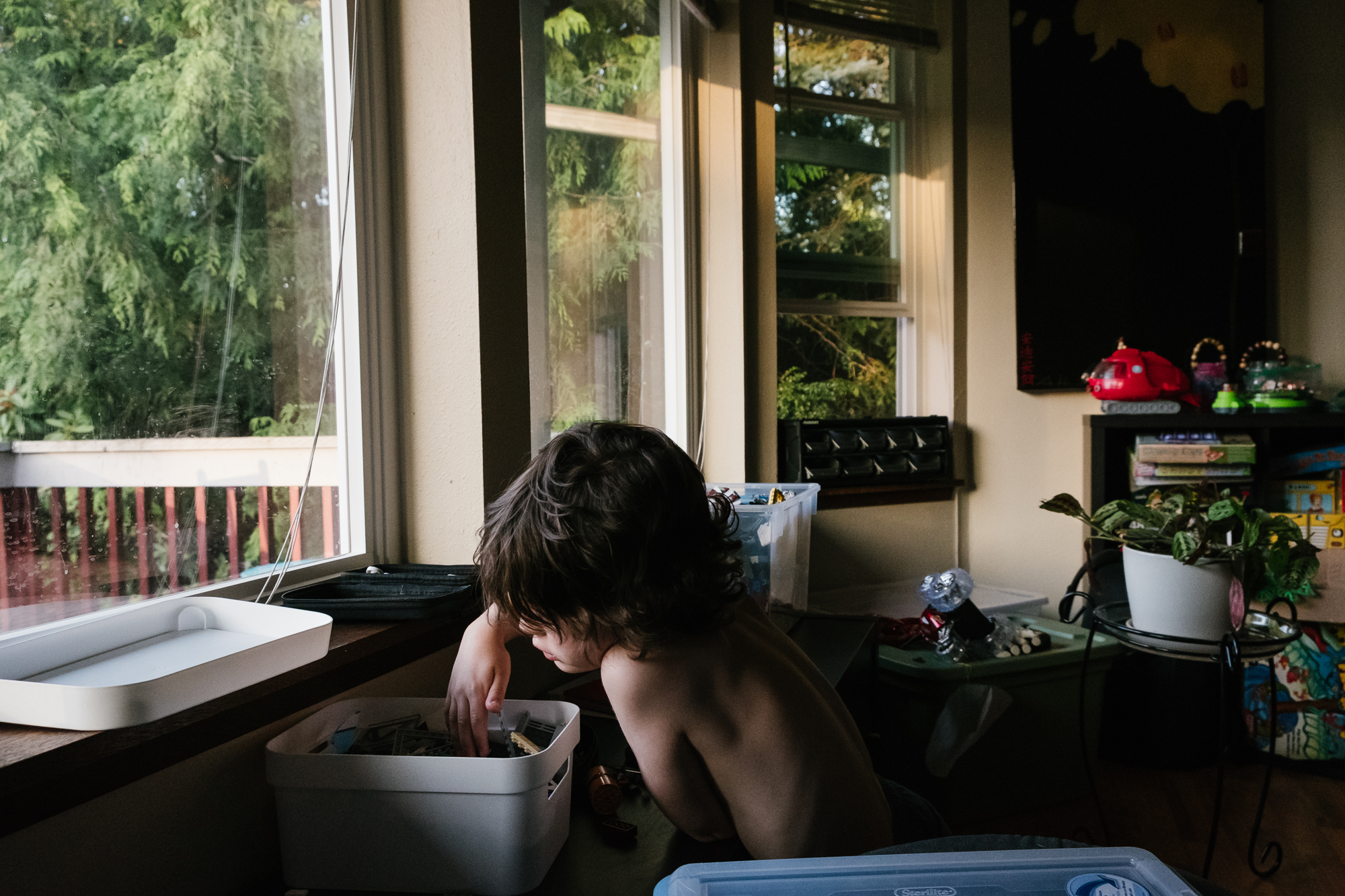 boy digging through Lego bin - documentary family photography