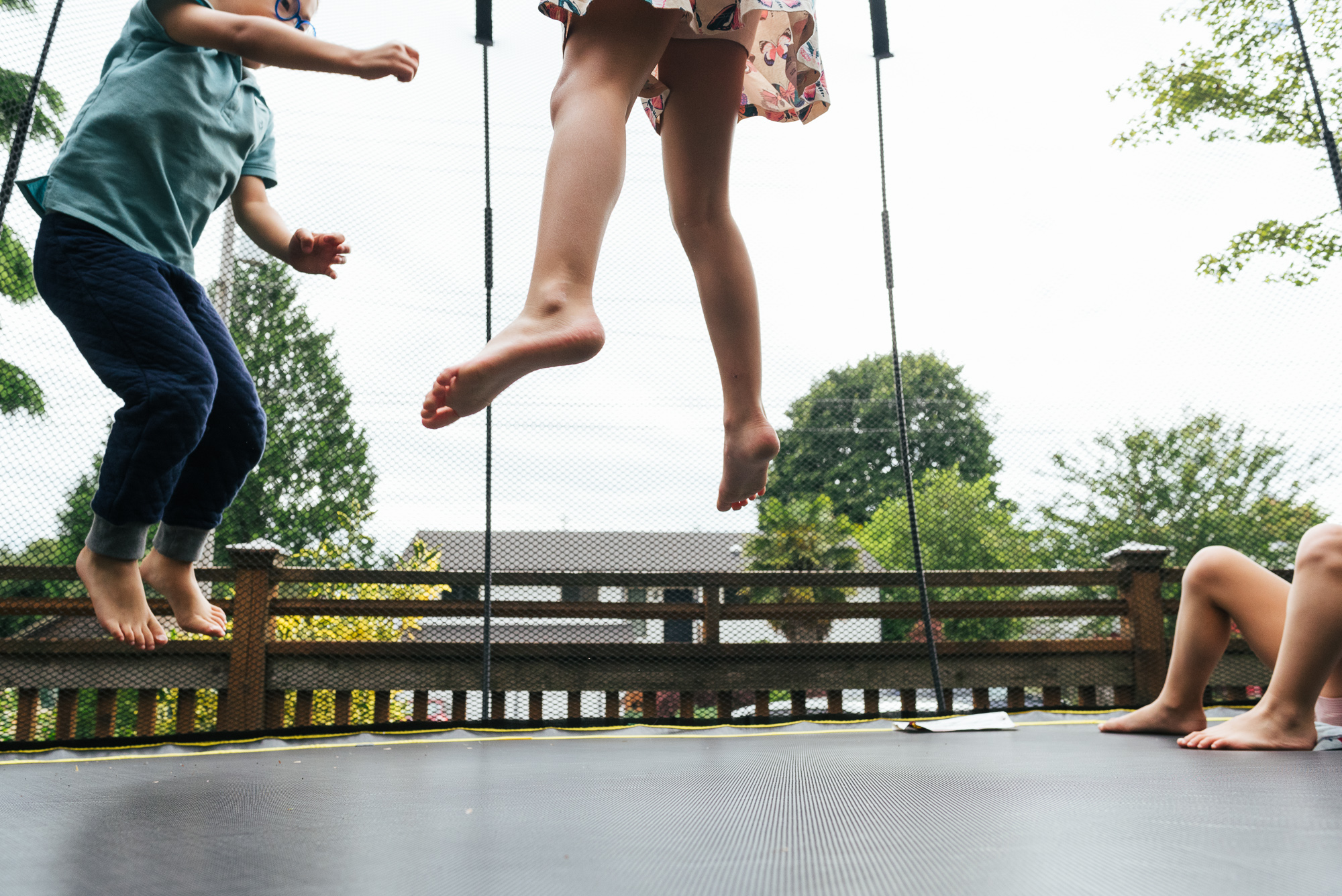 kids feet on trampoline - documentary family photography