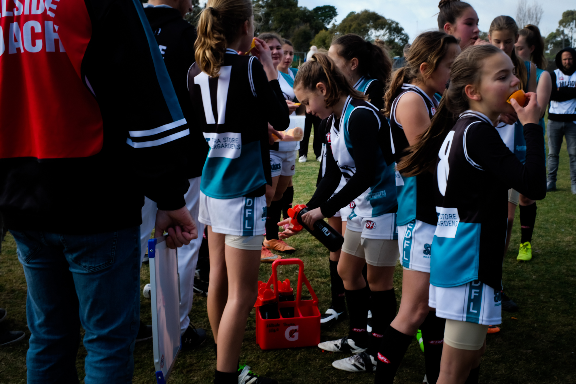 girls sporting team on sidelines - documentary family photography