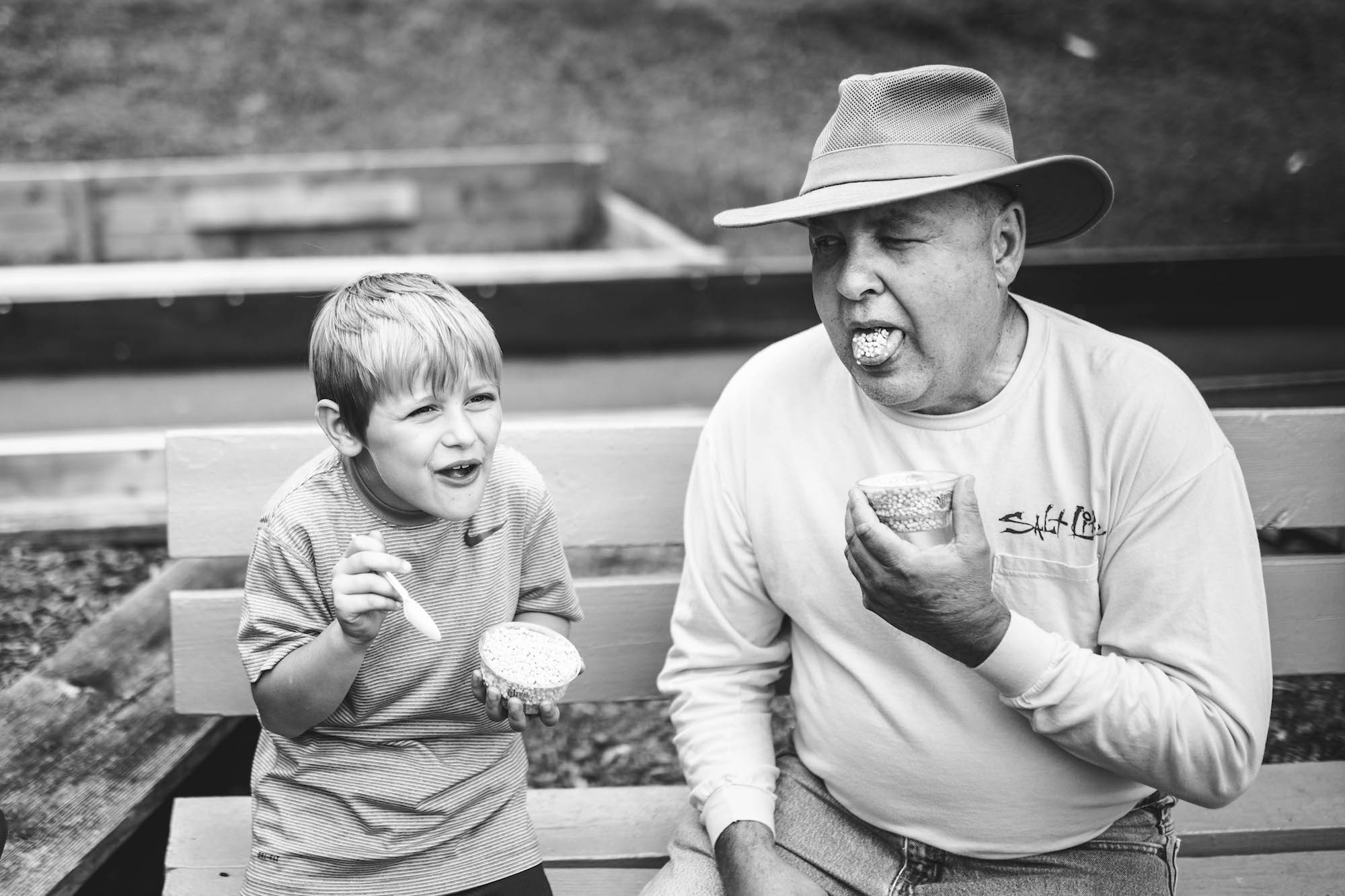 boy eating with grandfather - Documentary Family Photography
