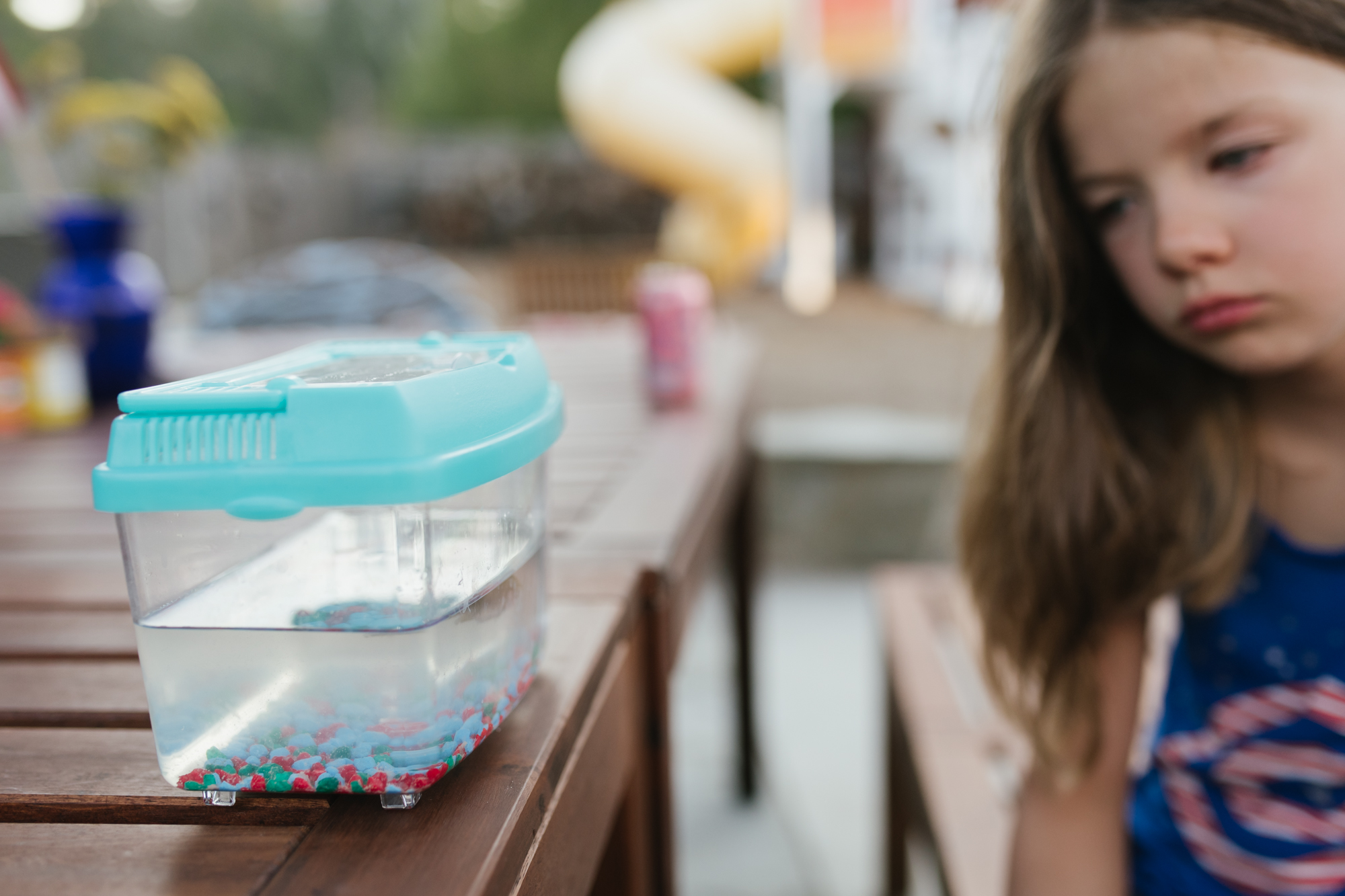 girl looking at fish bowl - Documentary Family Photography