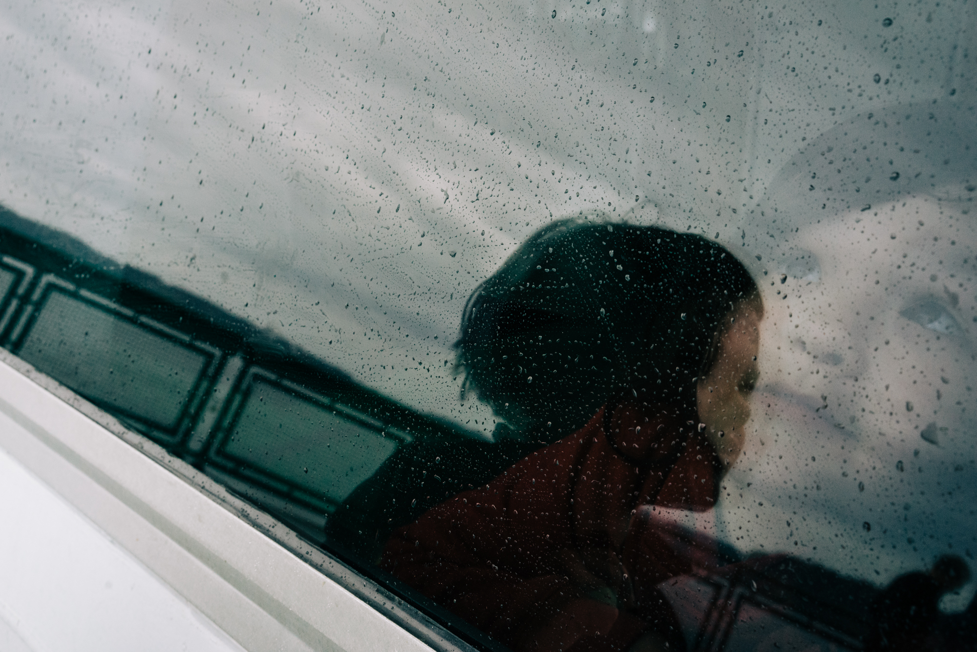 kid looking through window - Documentary Family Photography