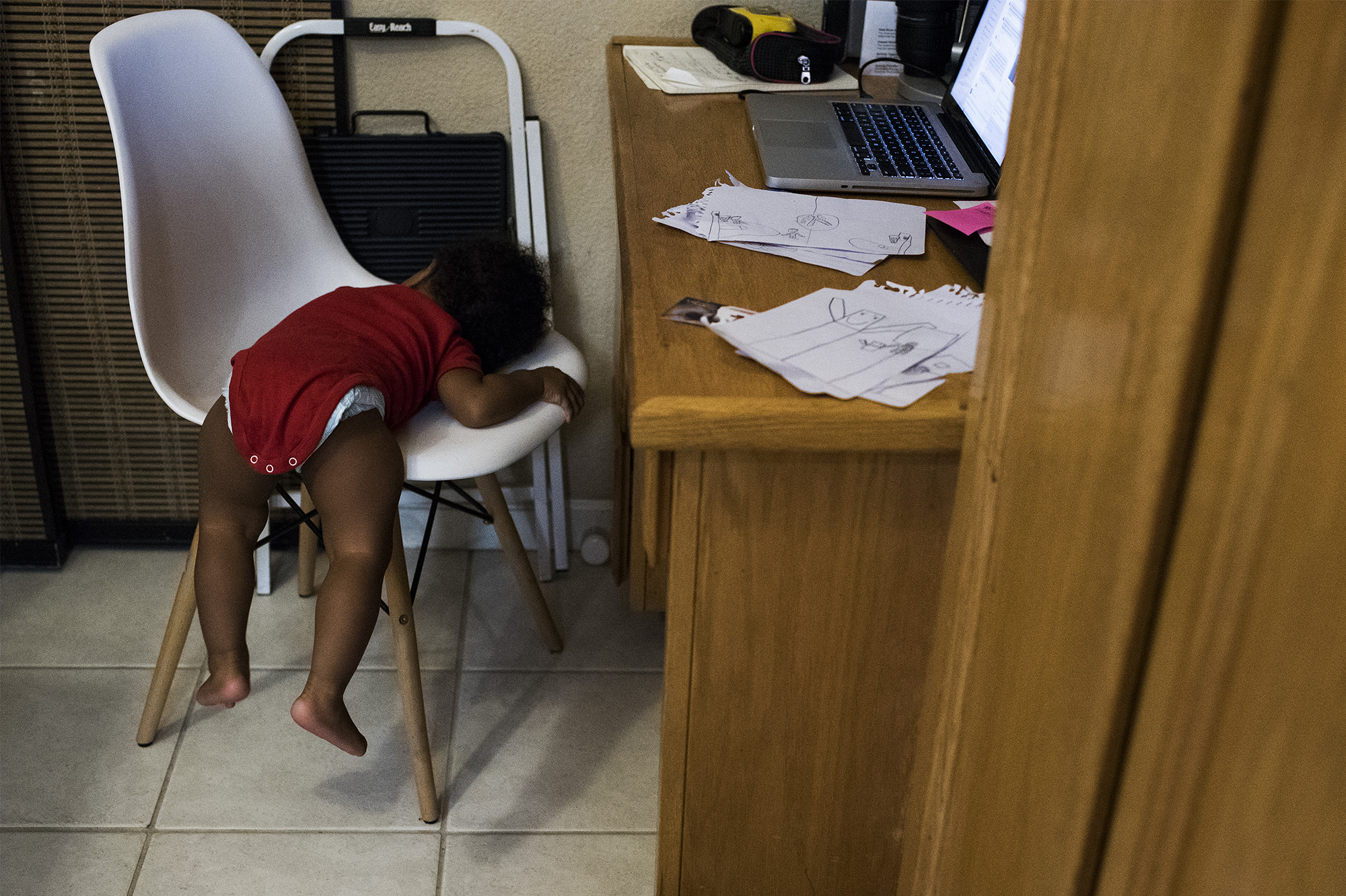 baby sprawled on office chair - documentary family photography