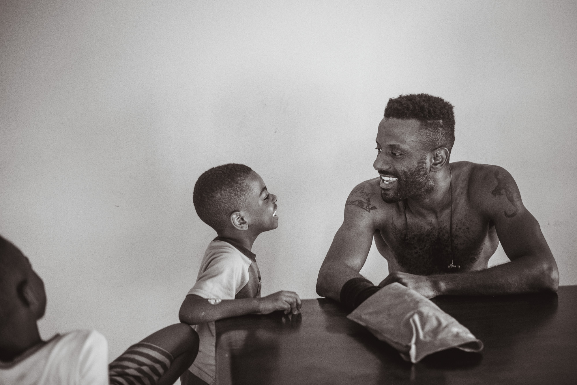 father and son makes faces at each other - documentary family photography