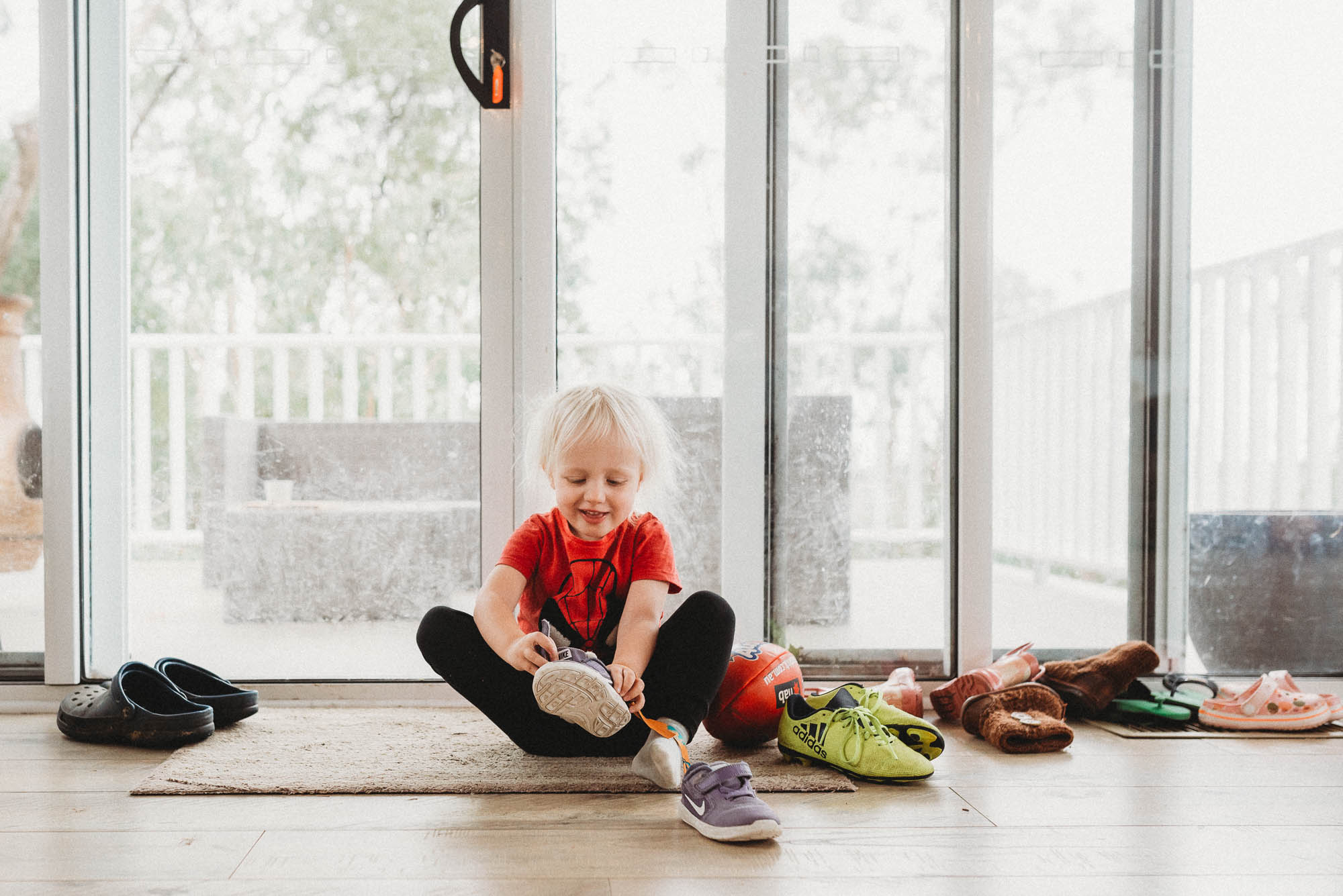 girl putting on shoes - documentary family photography