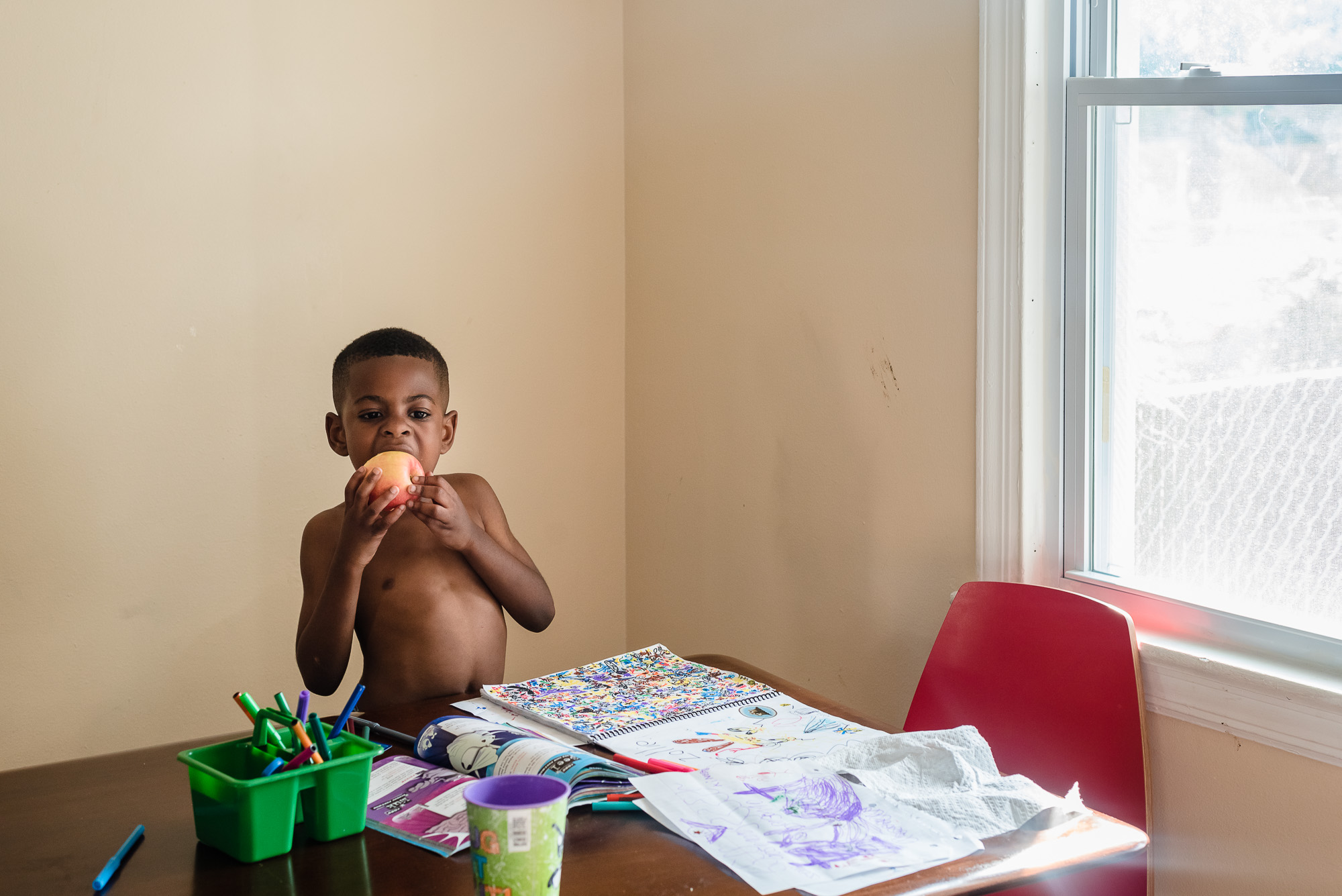 boy eating apple - documentary family photography