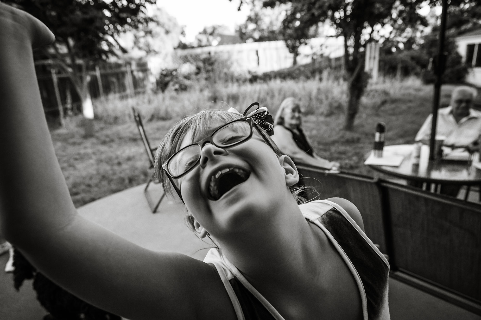 girl laughing into camera - documentary family photography