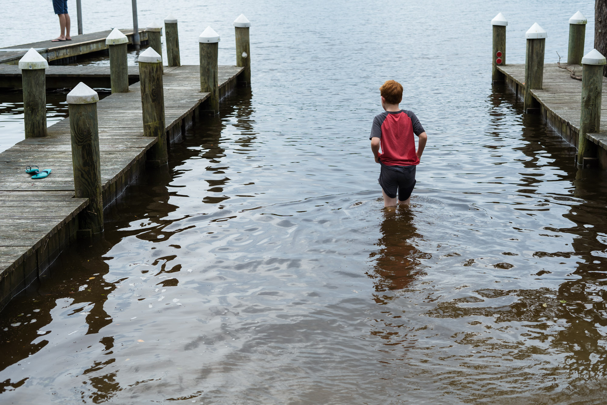 boy wading into water - documentary family photography